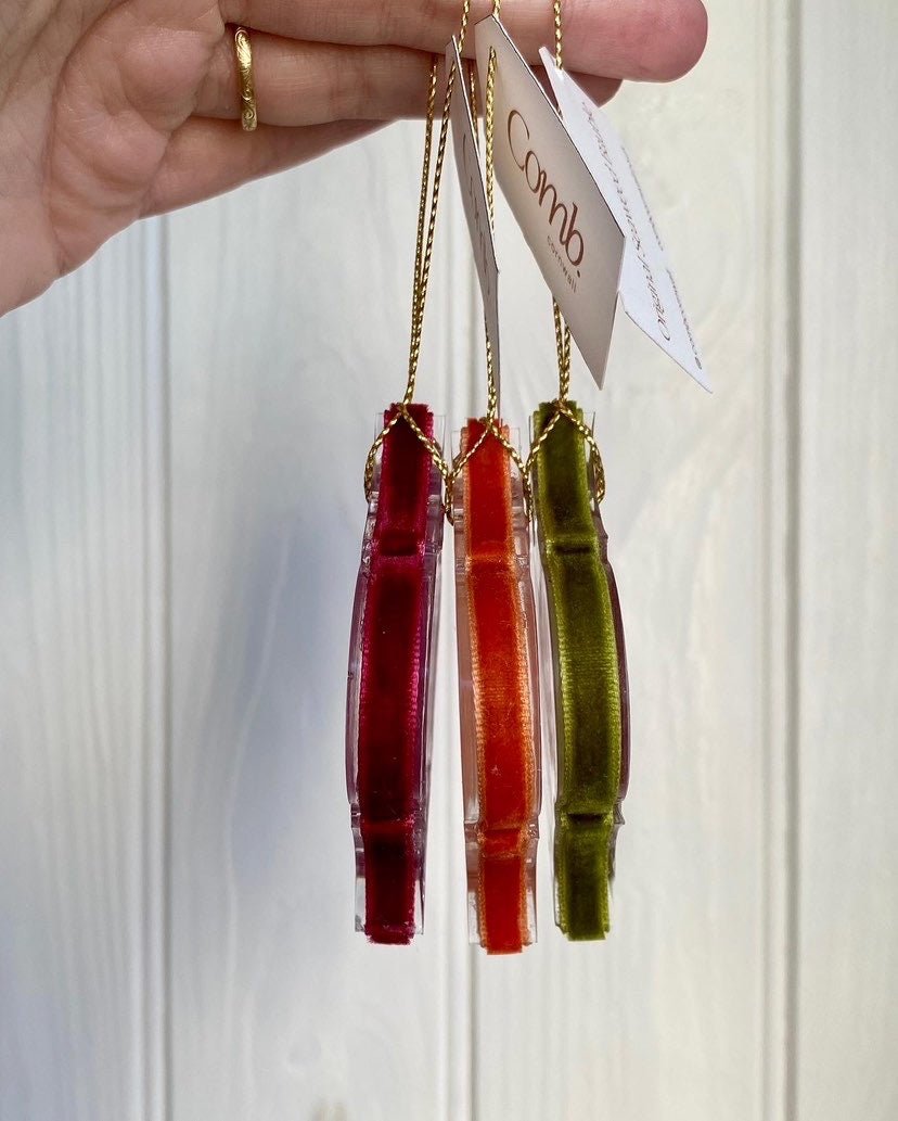 set of eco-resin seaweed baubles in red, orange and green, handmade luxury coastal Christmas decorations with real seaweed