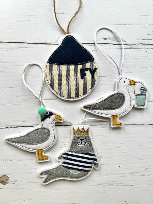 handmade fabric ornaments, nautical seagull seal decorations, embroidered coastal theme, striped beach house decor, hanging charm