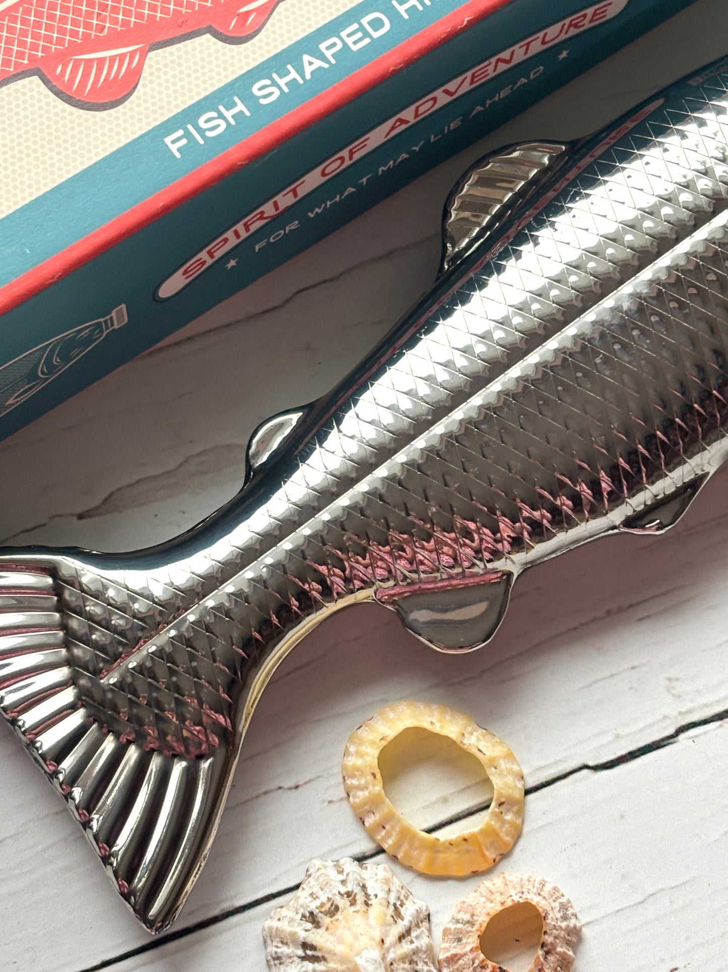 fish-shaped hip flask with detailed fin and scale texture, stainless steel novelty bottle with retro gift box