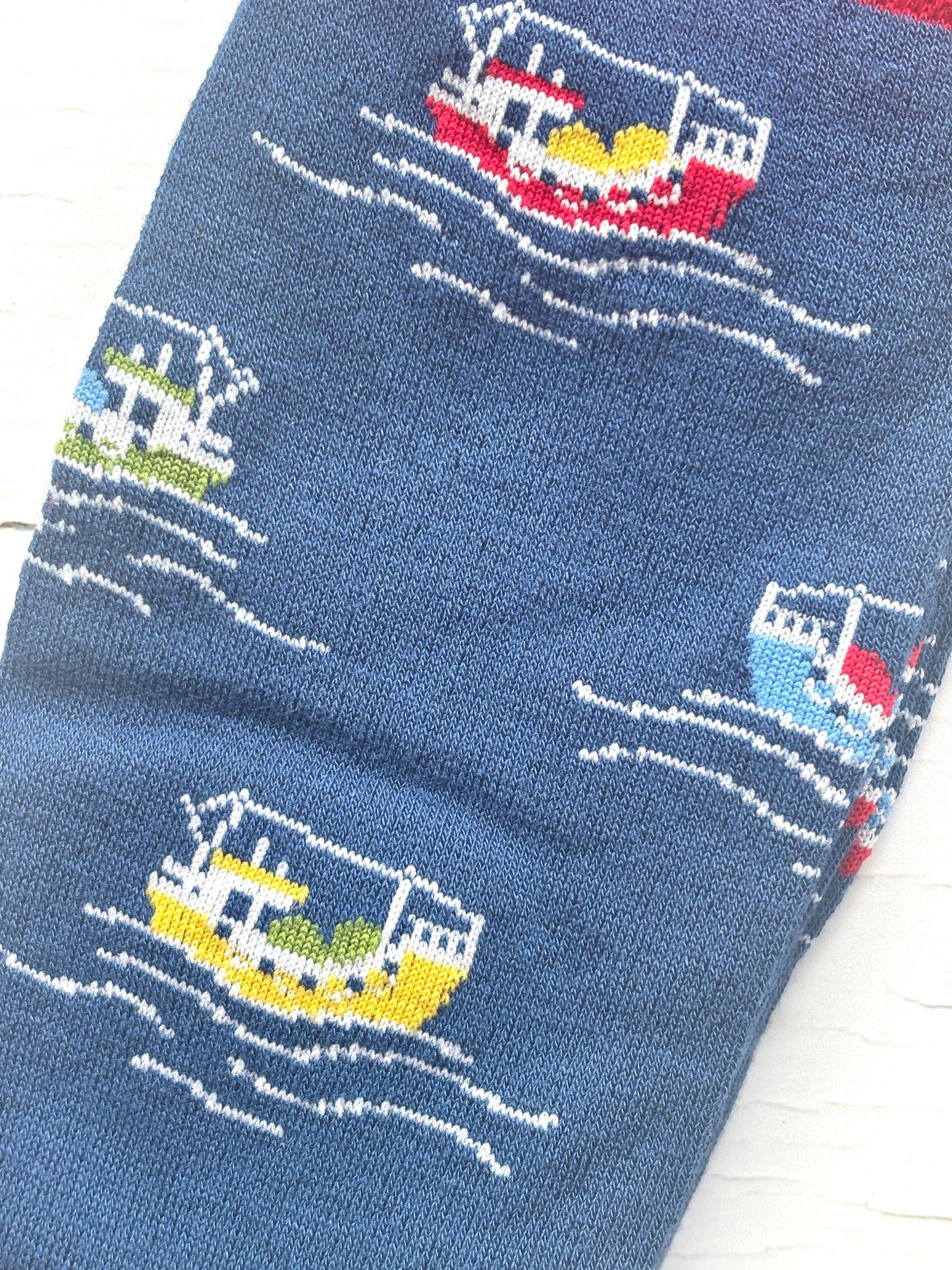 men’s novelty socks with vibrant fishing boats on ocean-blue knit—coastal style for nautical lovers and casual statement wear
