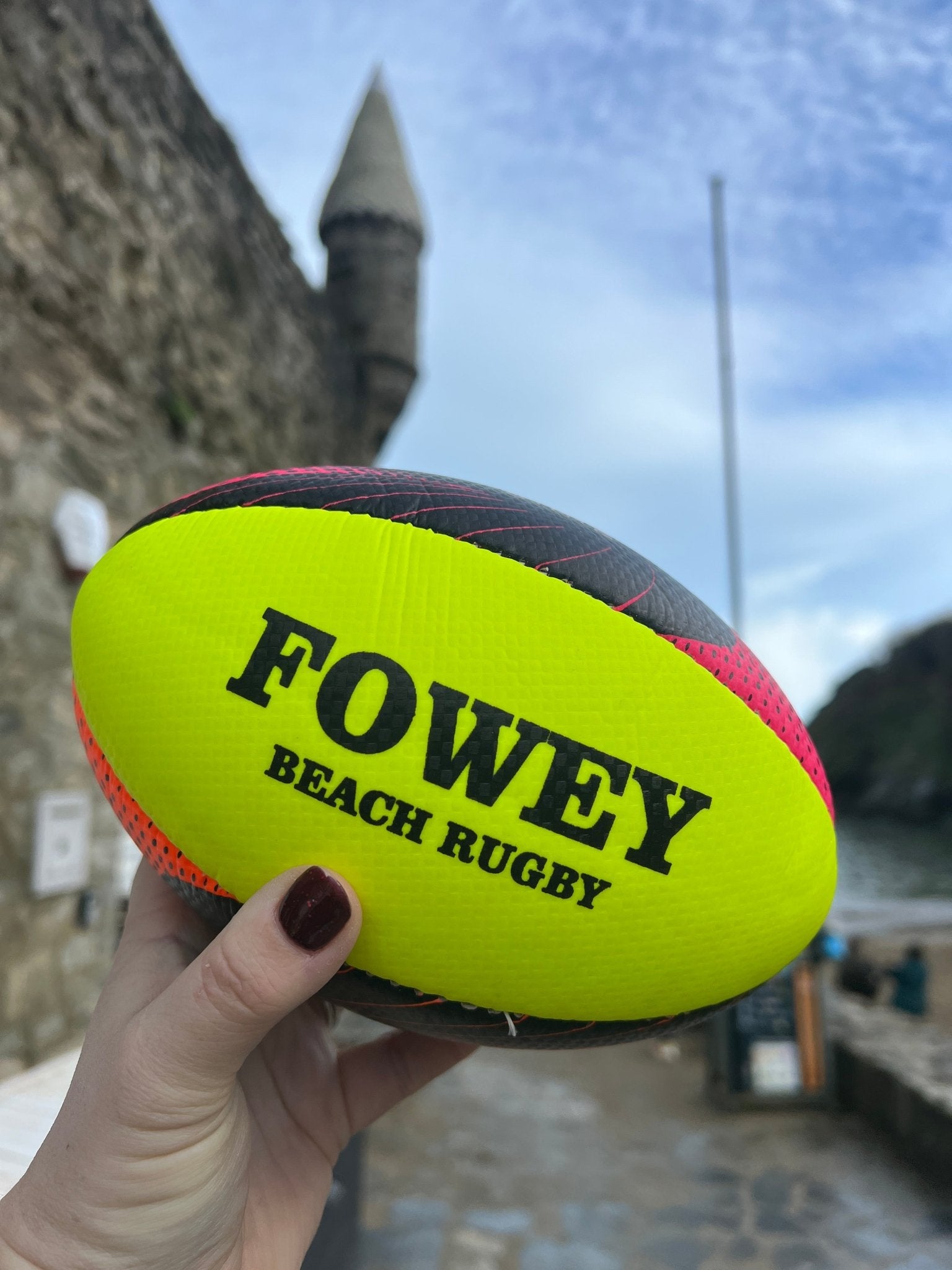 Fowey beach rugby ball outdoor sports equipment in neon yellow with black "FOWEY BEACH RUGBY" text water-resistant souvenir toy