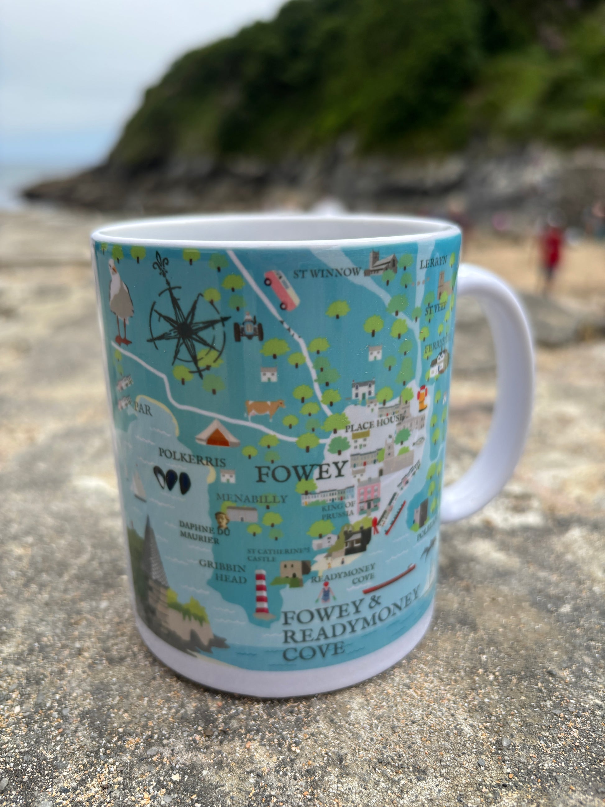 Fowey illustrated map mug ceramic coffee mug with colorful, detailed map print on a beach/coastal backdrop Cornwall souvenir drinkware