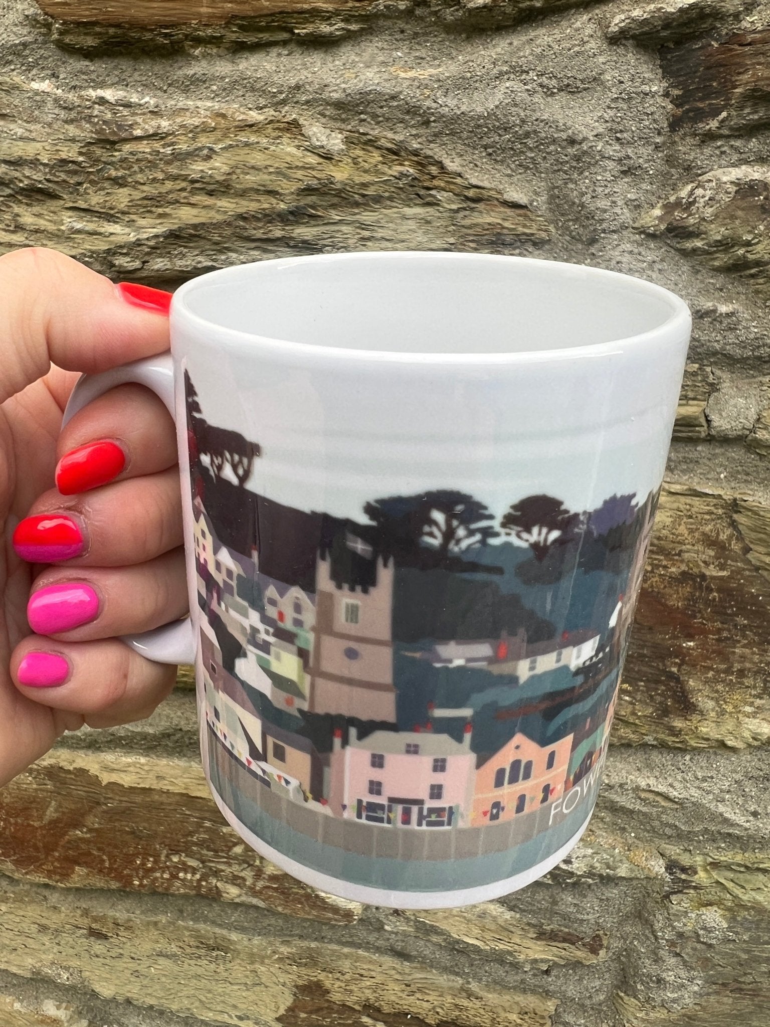 closeup shot of Fowey illustrated mug ceramic mug with a colorful, hand-drawn townscape scene Cornwall souvenir coffee cup detail
