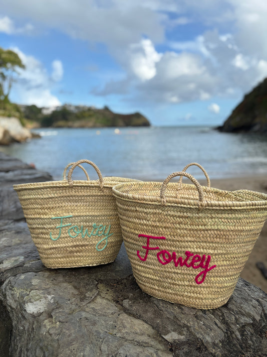 set of two customized straw beach totes with Fowey hand-embroidered in bright fuchsia and seafoam green coastal holiday bags