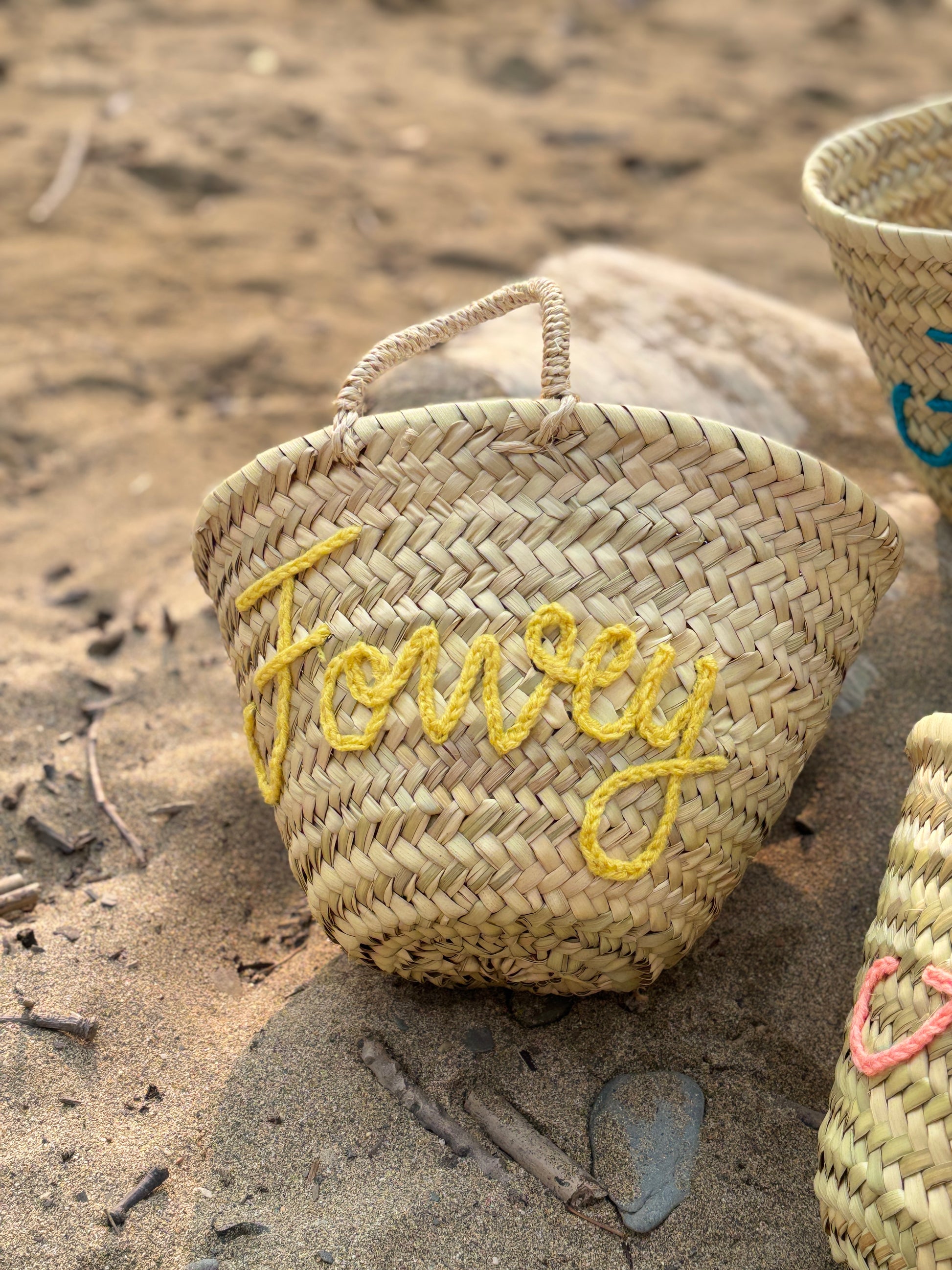small woven straw beach basket featuring "Fowey" embroidered in sunny yellow yarn summer handbag, custom straw tote