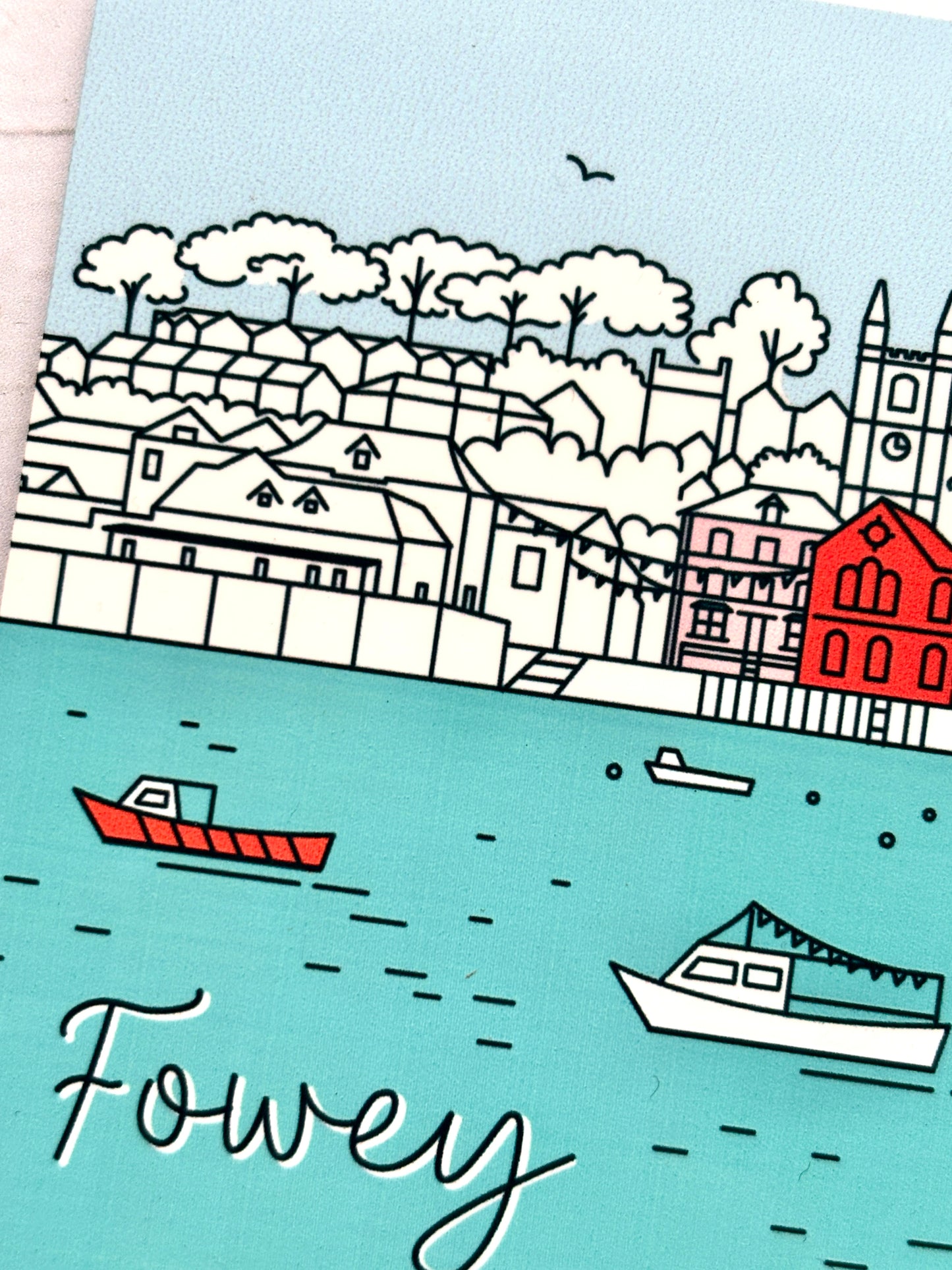 closeup shot of Fowey harbor coaster with illustrated boats, clock tower, and colorful seaside buildings—charming coastal decor