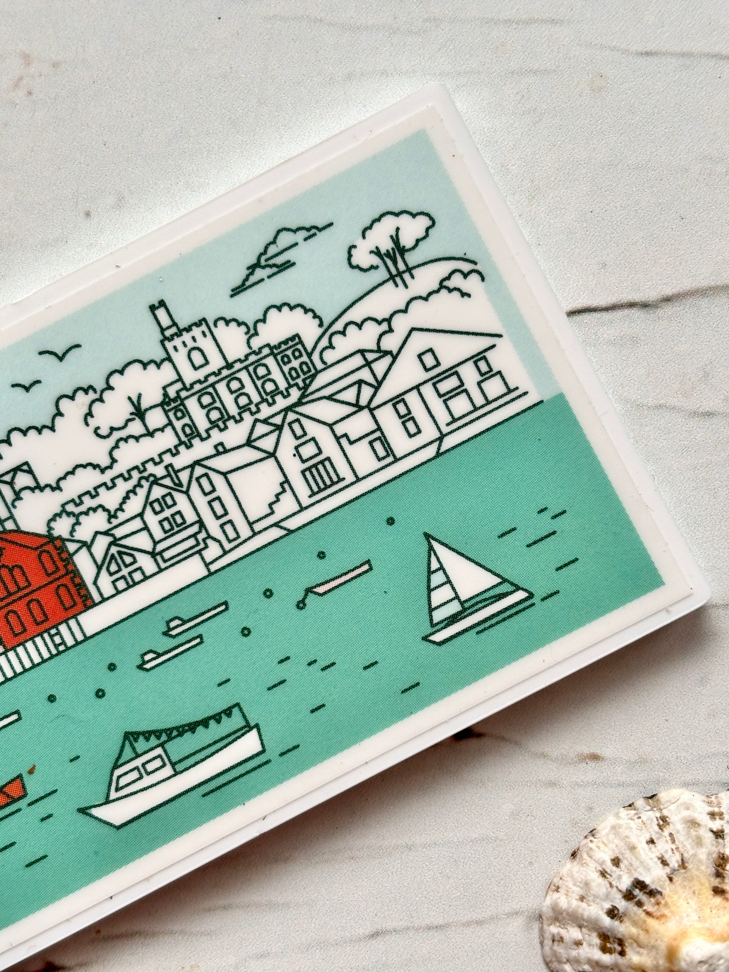 closeup shot of Fowey skyline magnet with sailboats, castle, and church spires—stylized coastal souvenir for nautical fridge decor