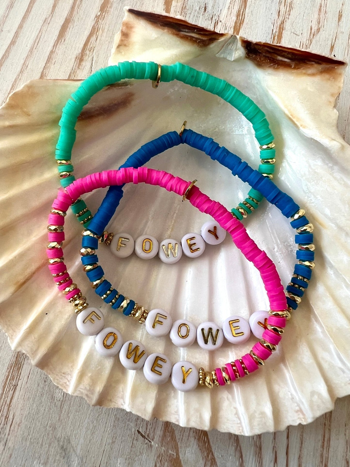 bright sweetie-style beaded bracelet with gold accents and FOWEY letter beads, colourful handmade coastal jewellery