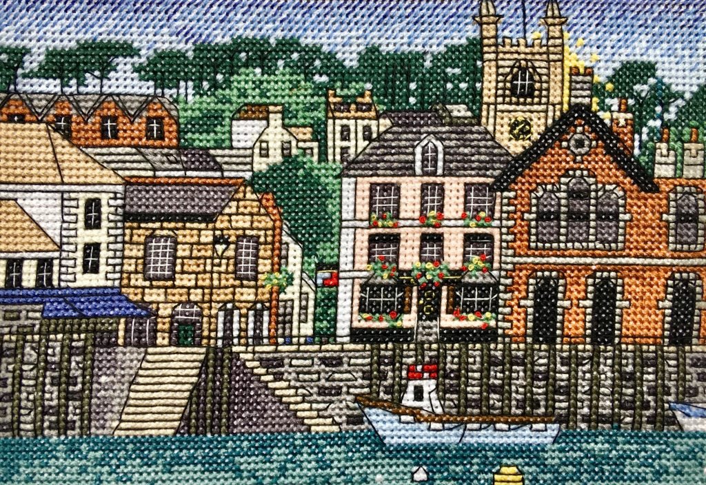 Fowey town cross stitch detail, colorful harbour buildings needlework closeup, Cornwall coastal embroidery texture