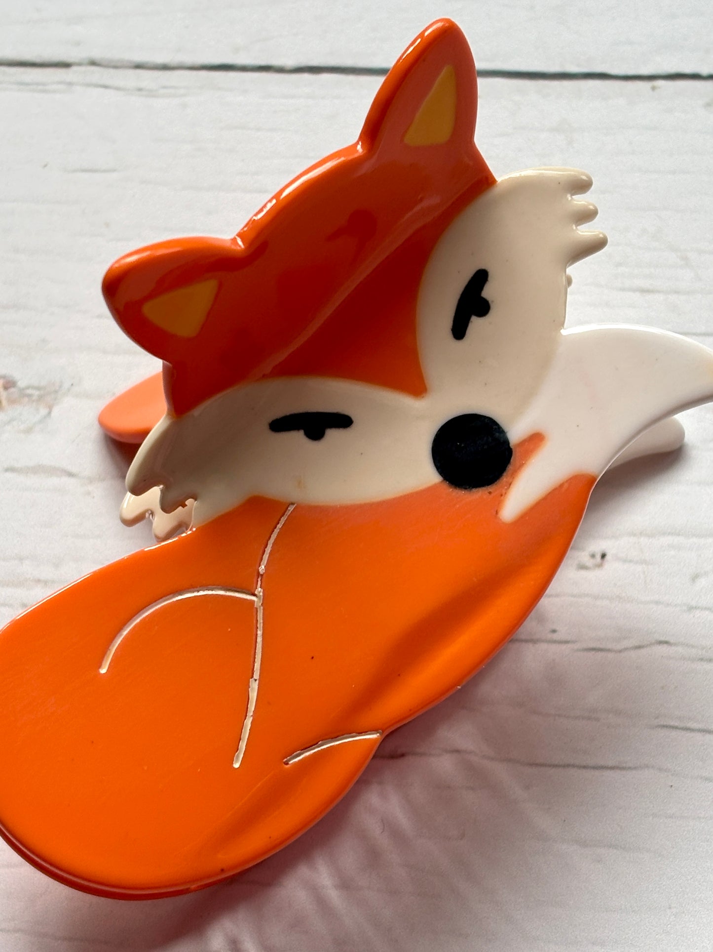 fox hair claw—bright orange clip with white accents, cartoon ears, and secure grip for whimsical woodland-inspired styling