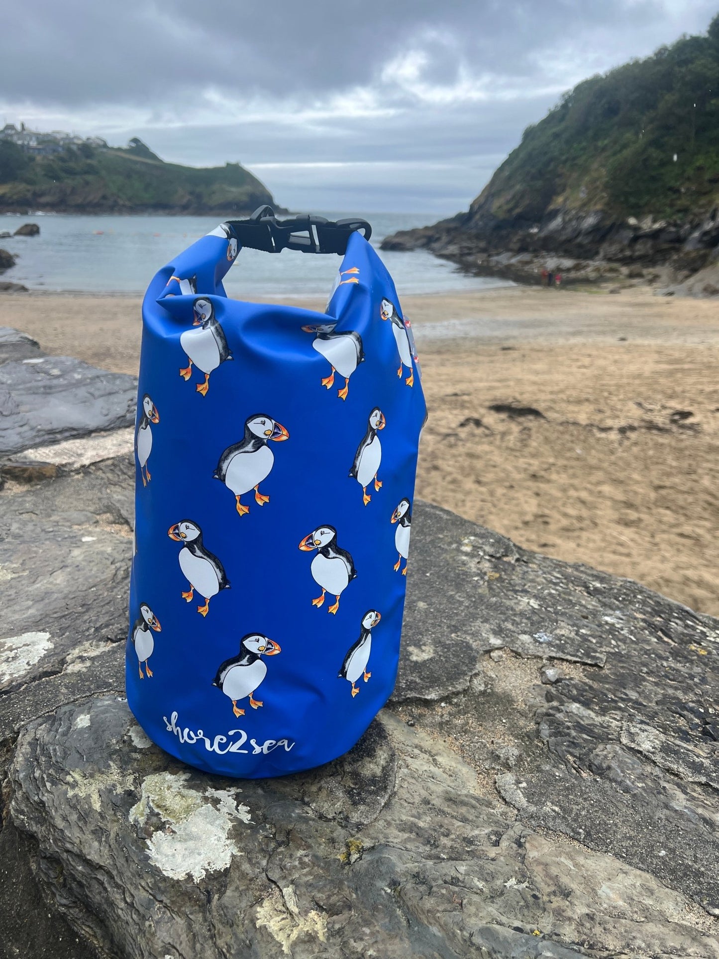 blue dry bag featuring a cute and funky puffin print waterproof protection for beach gear, paddling, and outdoor sports