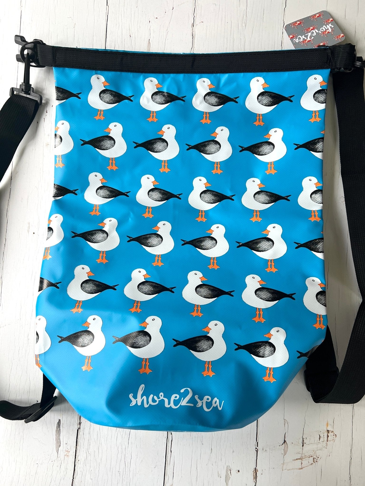 blue waterproof dry bag with a nautical seagull pattern durable gear for watersports, kayaking, and outdoor adventures