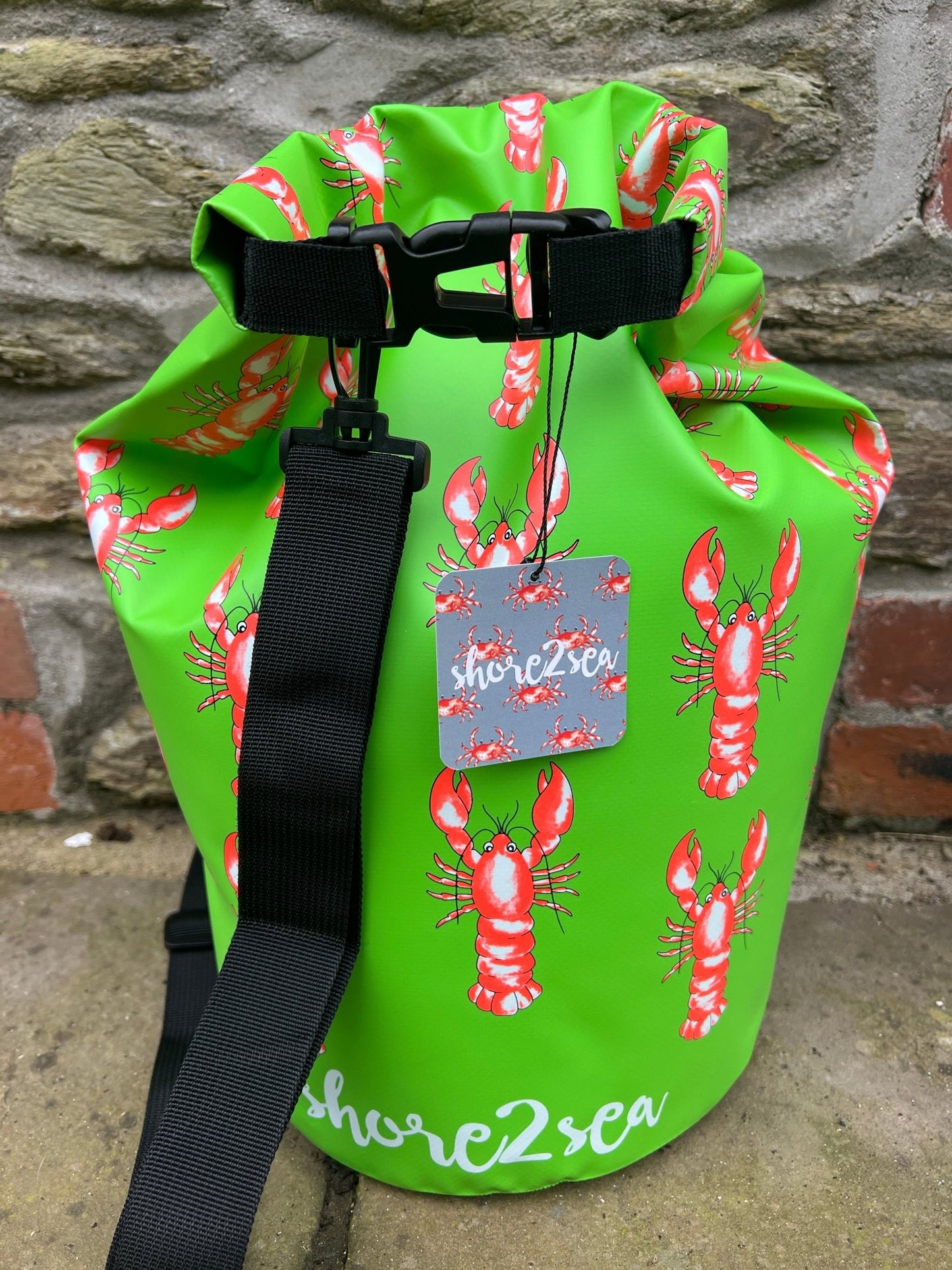 vibrant green waterproof dry bag with a funky lobster pattern essential gear for boating, kayaking, and keeping items dry