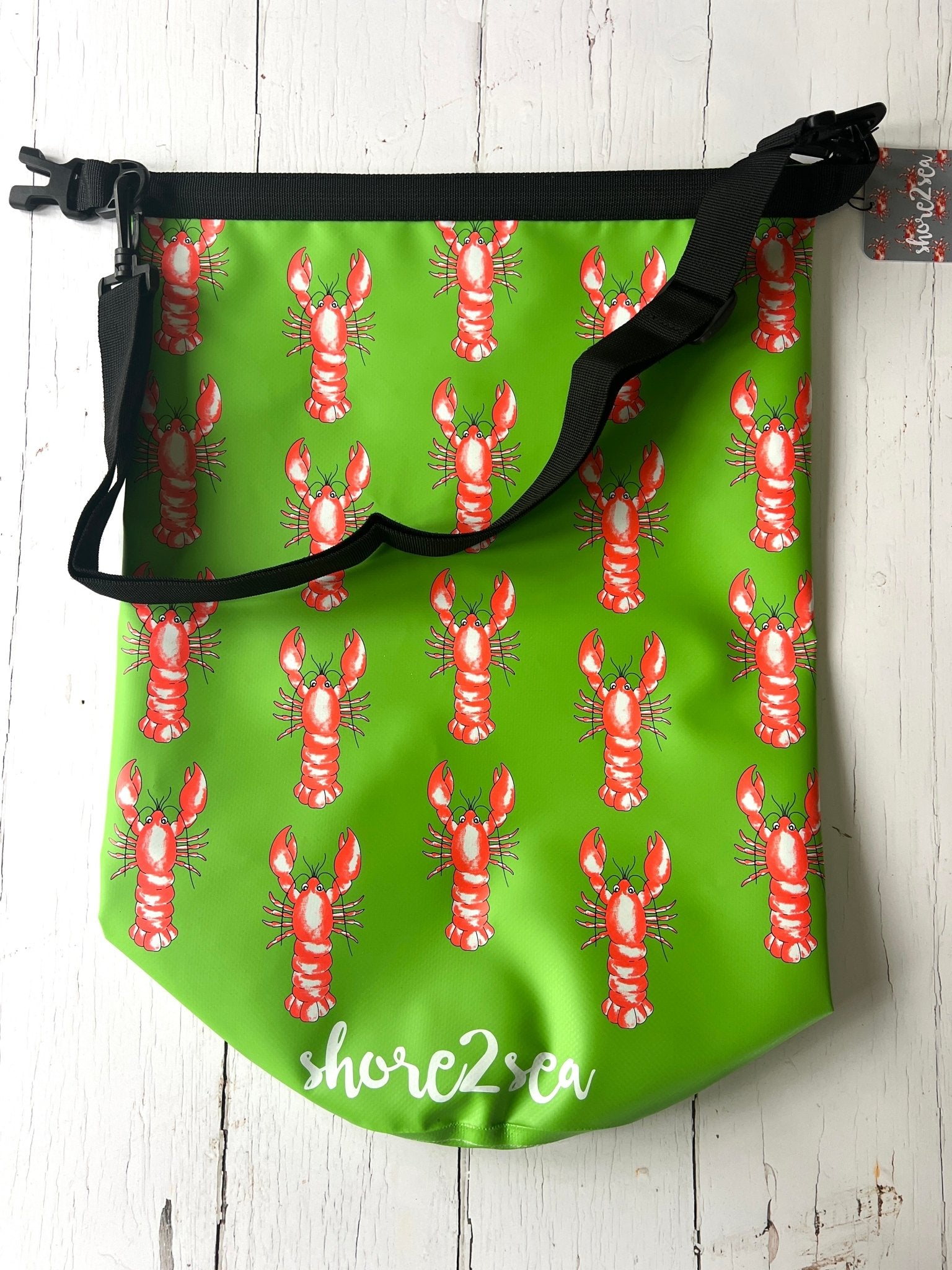 green waterproof dry bag with red lobster print—fun nautical beach gear for coastal adventures and boat trips