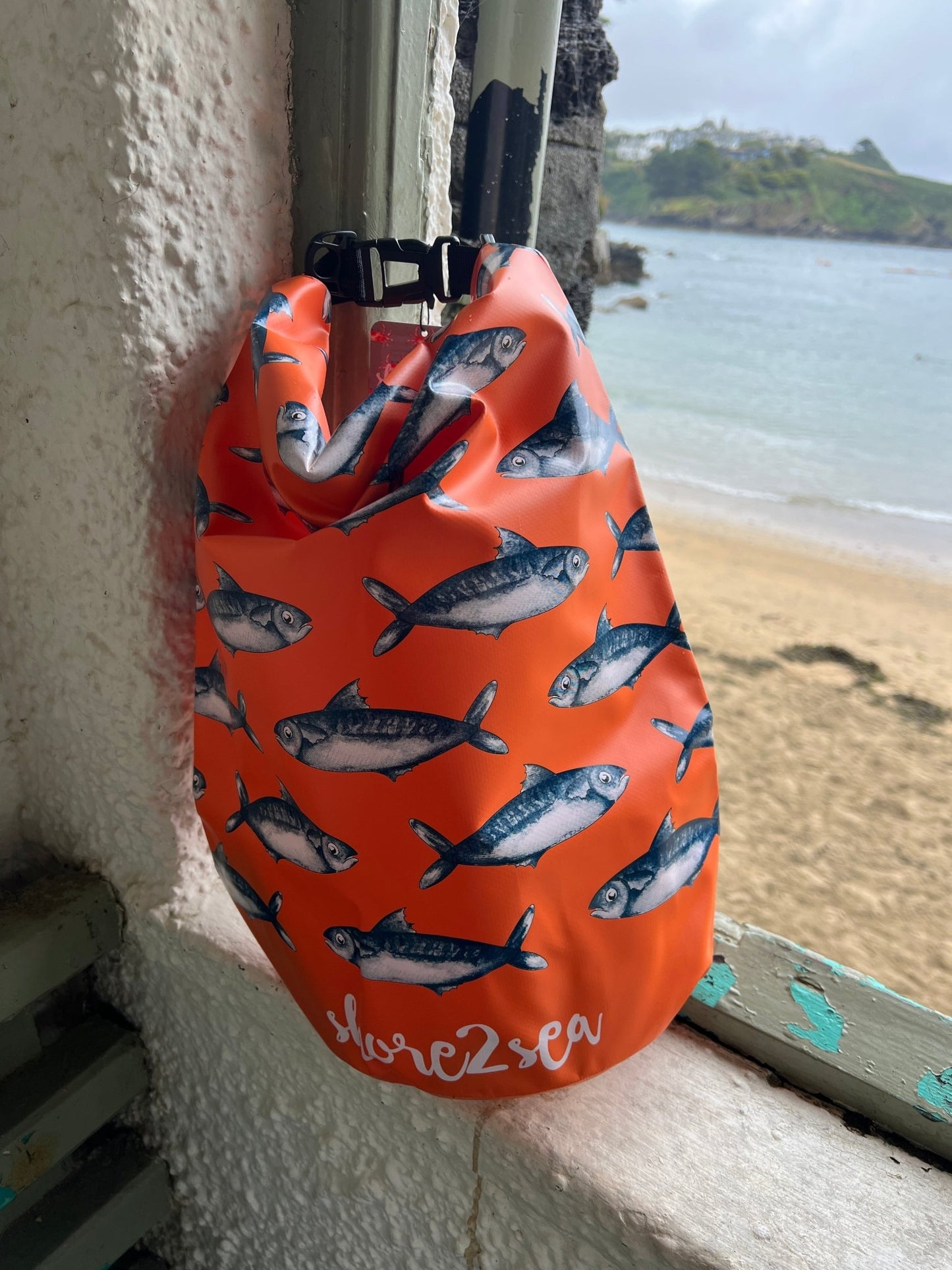 orange waterproof dry bag with a funky fish pattern durable storage for beach days, SUP, and water activities