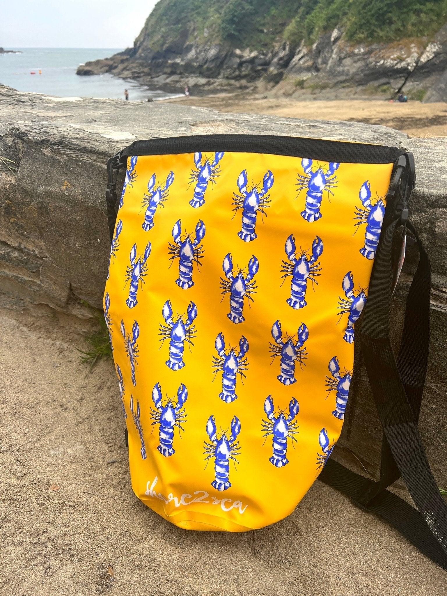 yellow waterproof dry bag with blue lobster print—fun nautical gear for beach, boat, or coastal adventures