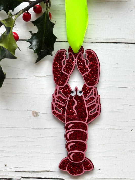 glittery lobster Christmas decor—red glitter ornament with cartoon eyes and green ribbon, perfect for coastal holiday tree décor