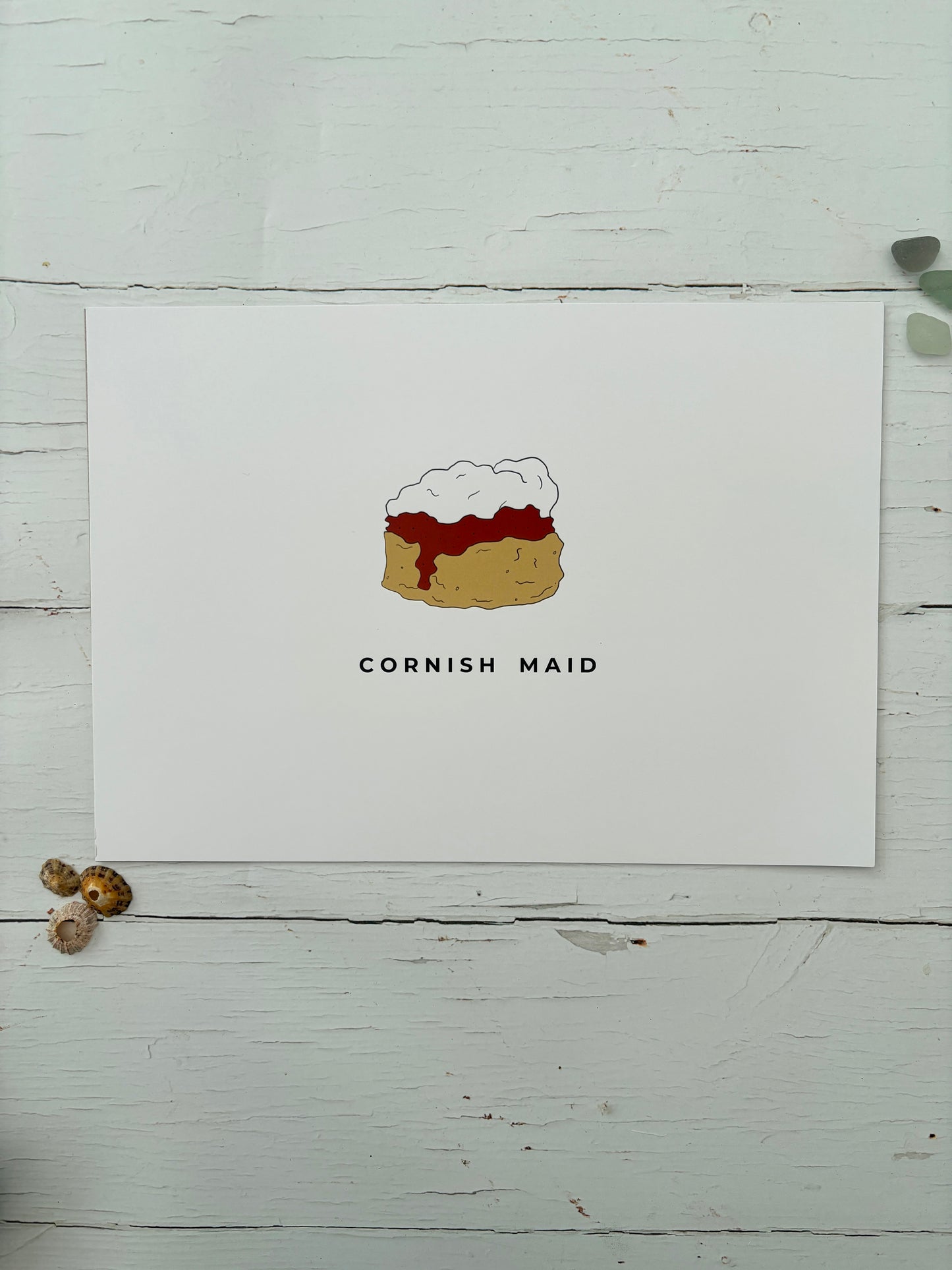 an a4 art print titled 'Cornish Maid' featuring a minimalist illustration of a scone with jam and clotted cream foodie gift, Cornwall art