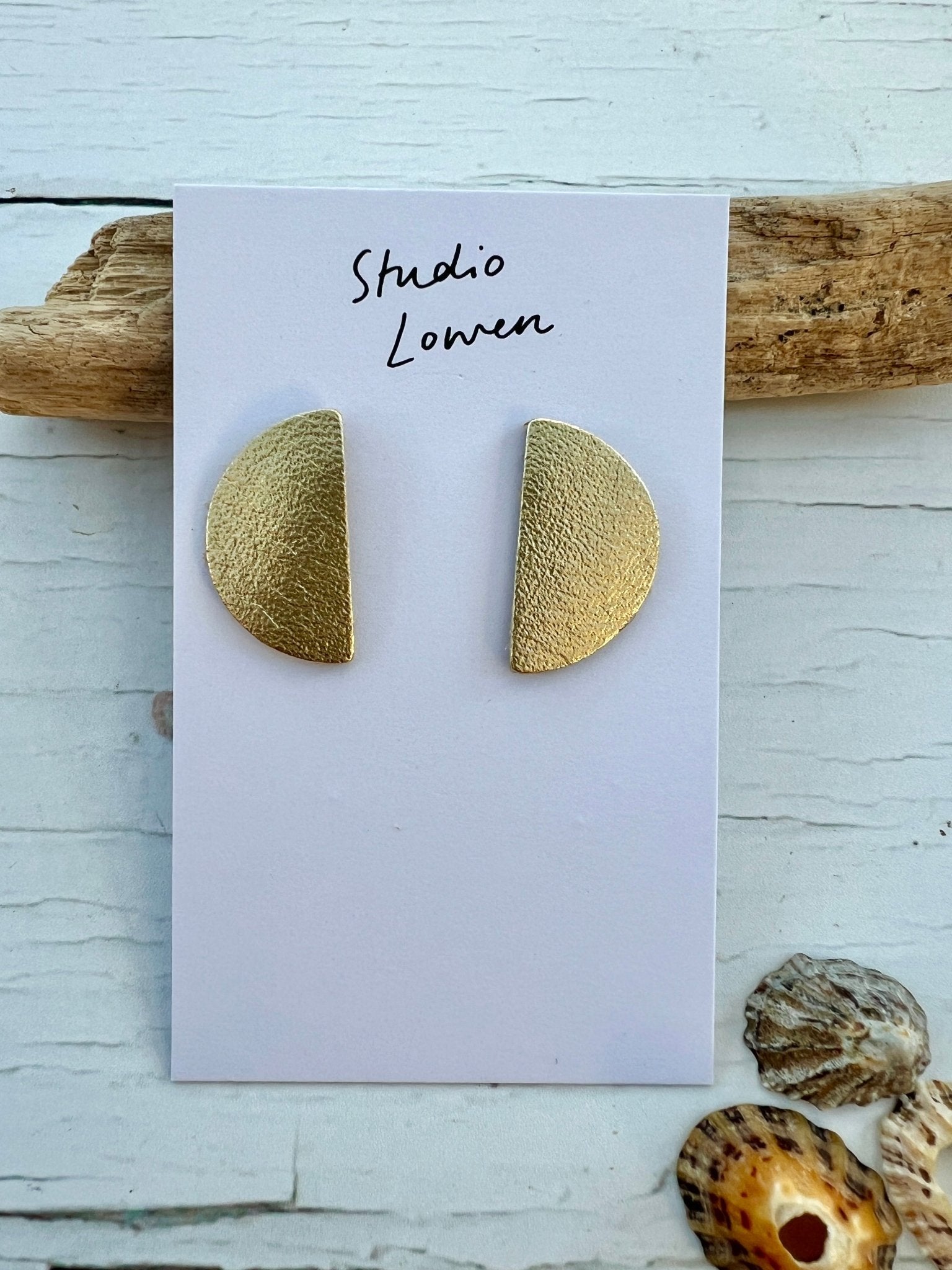 gold half-moon stud earrings made from textured vegan leather handmade jewellery with a modern geometric and statement style