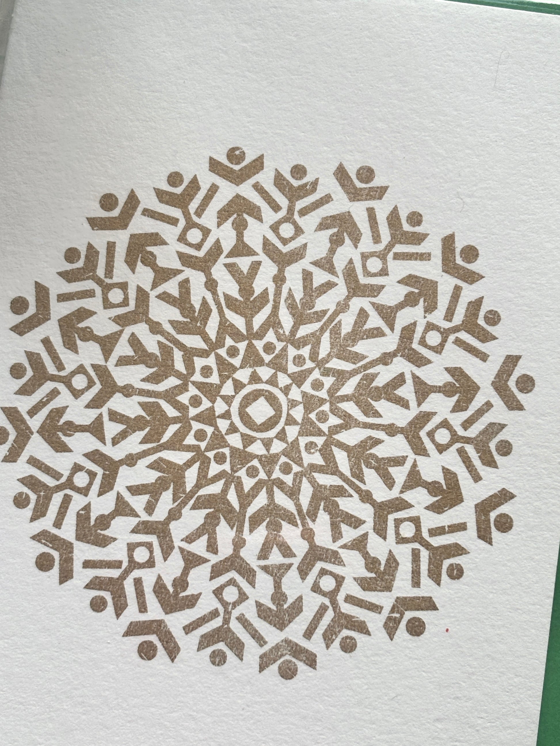 closeup shot of gold foil snowflake card—detailed geometric design on luxe paper elegant Christmas stationery with festive sparkle