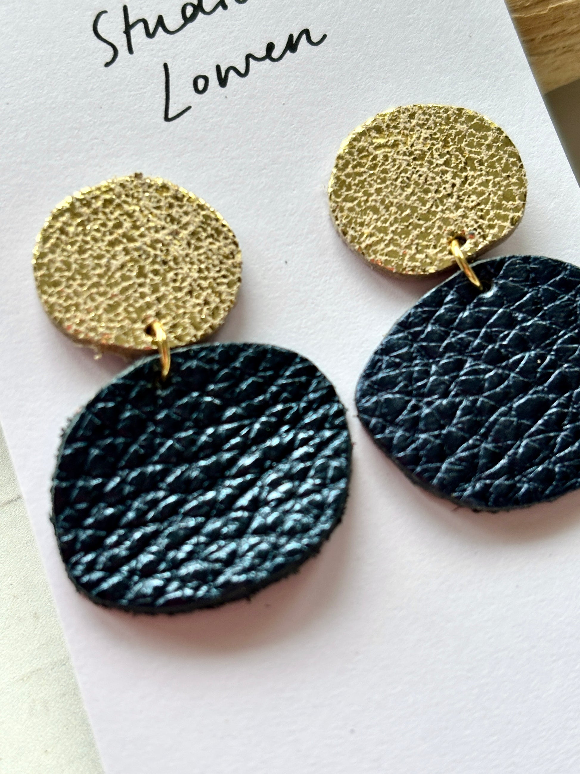 close-up metallic navy blue leather-effect dangle earrings gold textured stud handmade statement jewelry gift