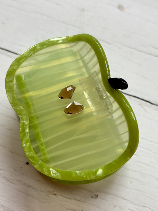 glossy green apple hair claw with striped body and gem-like seeds—playful, secure grip for everyday styling