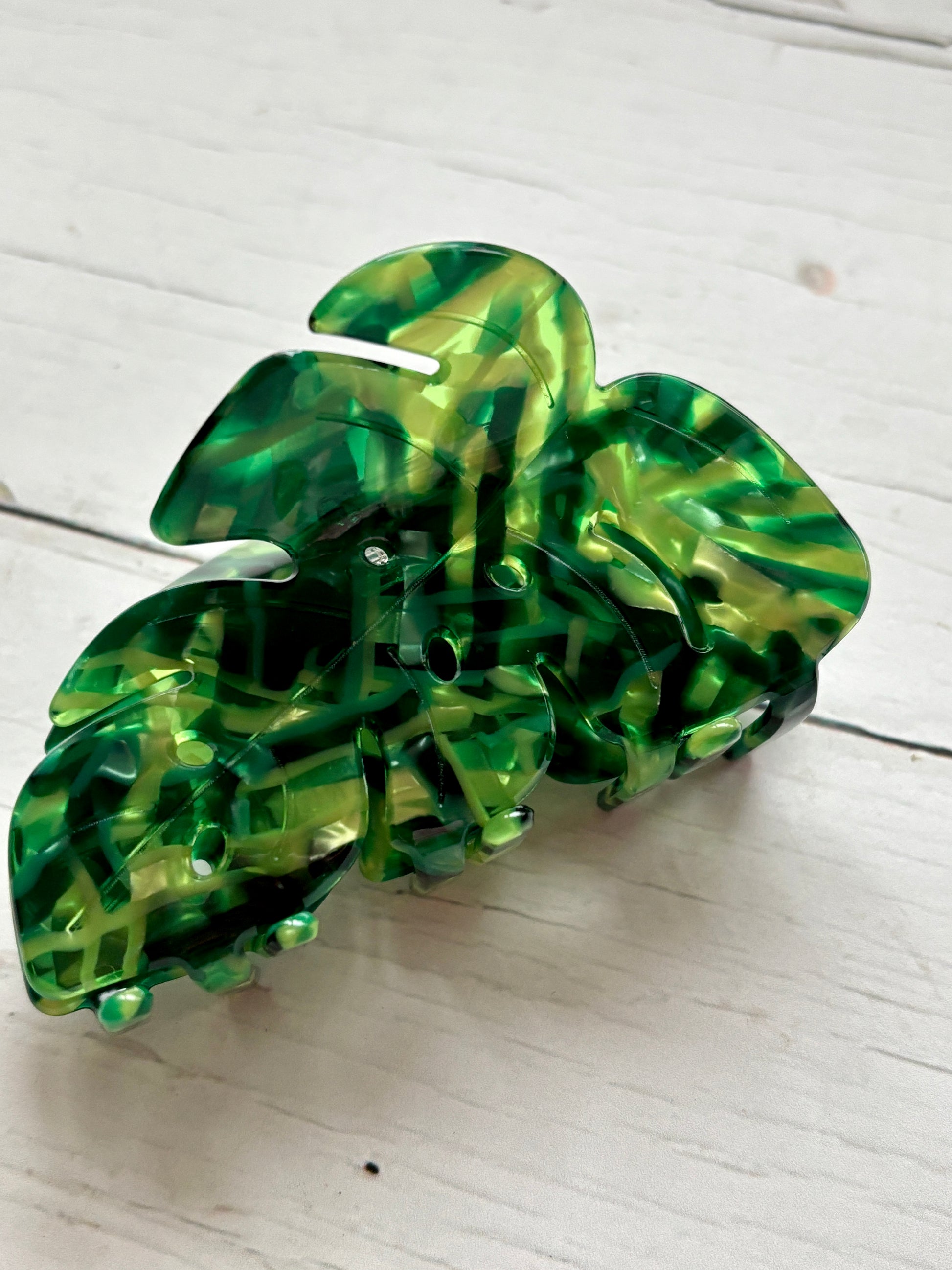 monstera leaf hair claw clip in a vibrant green and yellow marbled acrylic tropical hair accessory, plant lover gift