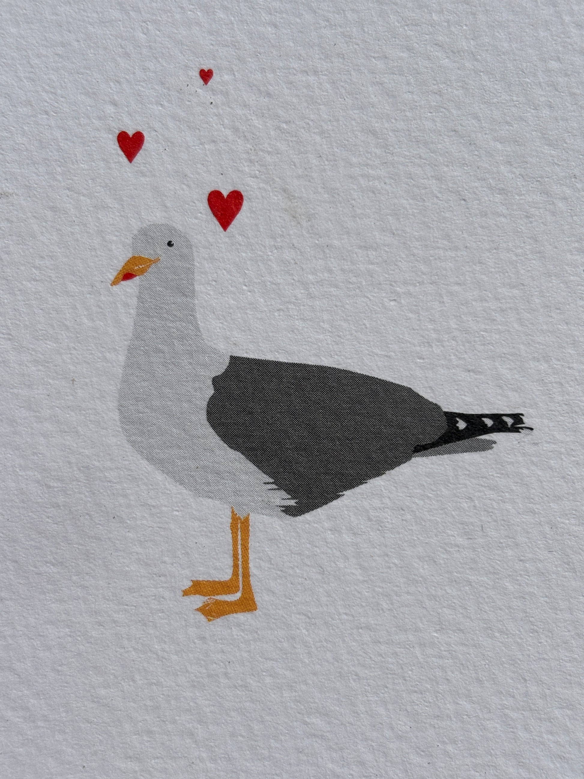 closeup shot of a detailed seagull and floating hearts minimalist romantic card with a funny pun: "Gull Of My Dreams." cute nautical pun stationery