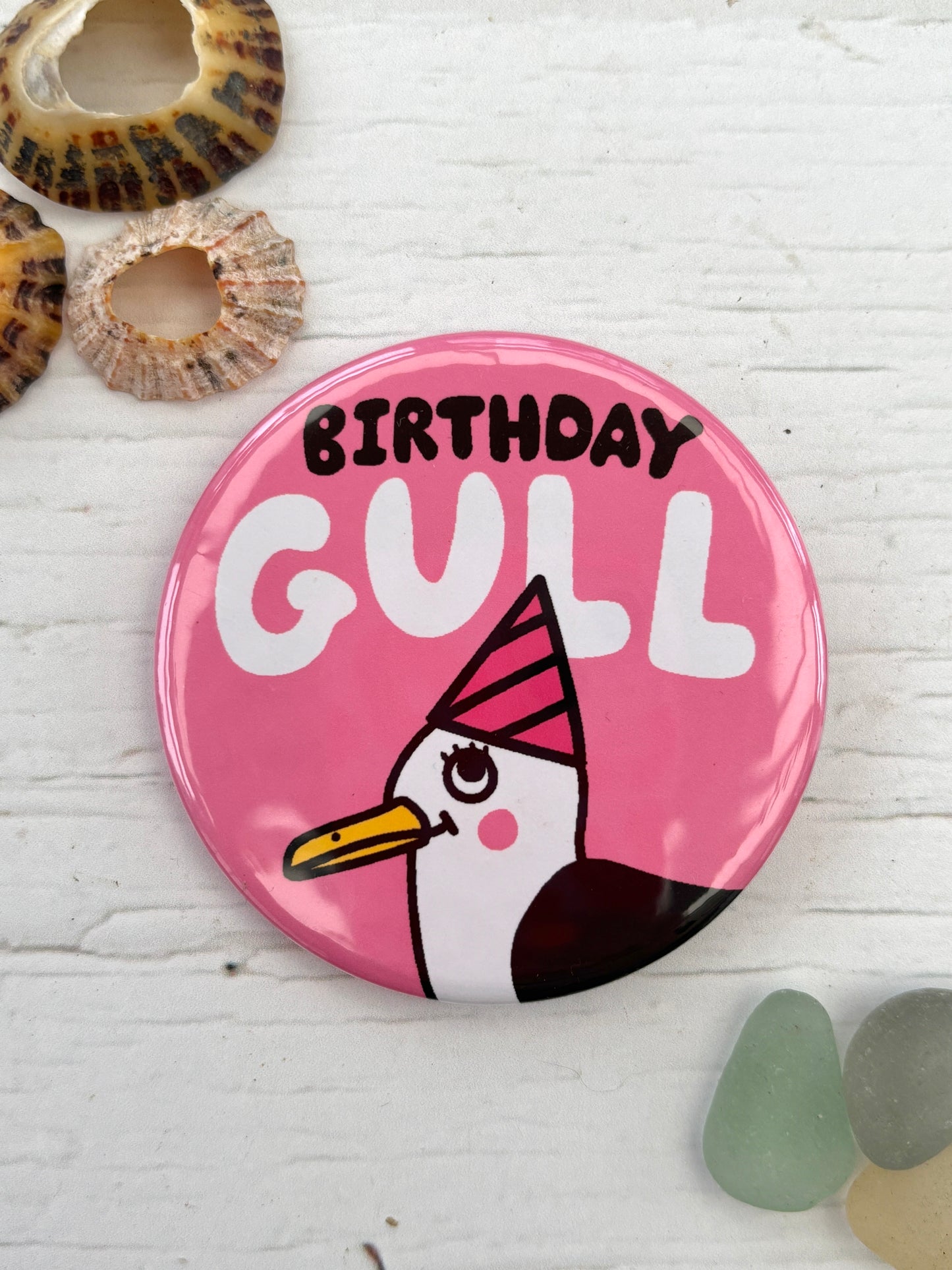pink 'Birthday Gull' badge featuring a seagull with a party hat fun nautical pin and birthday party accessory or coastal gift