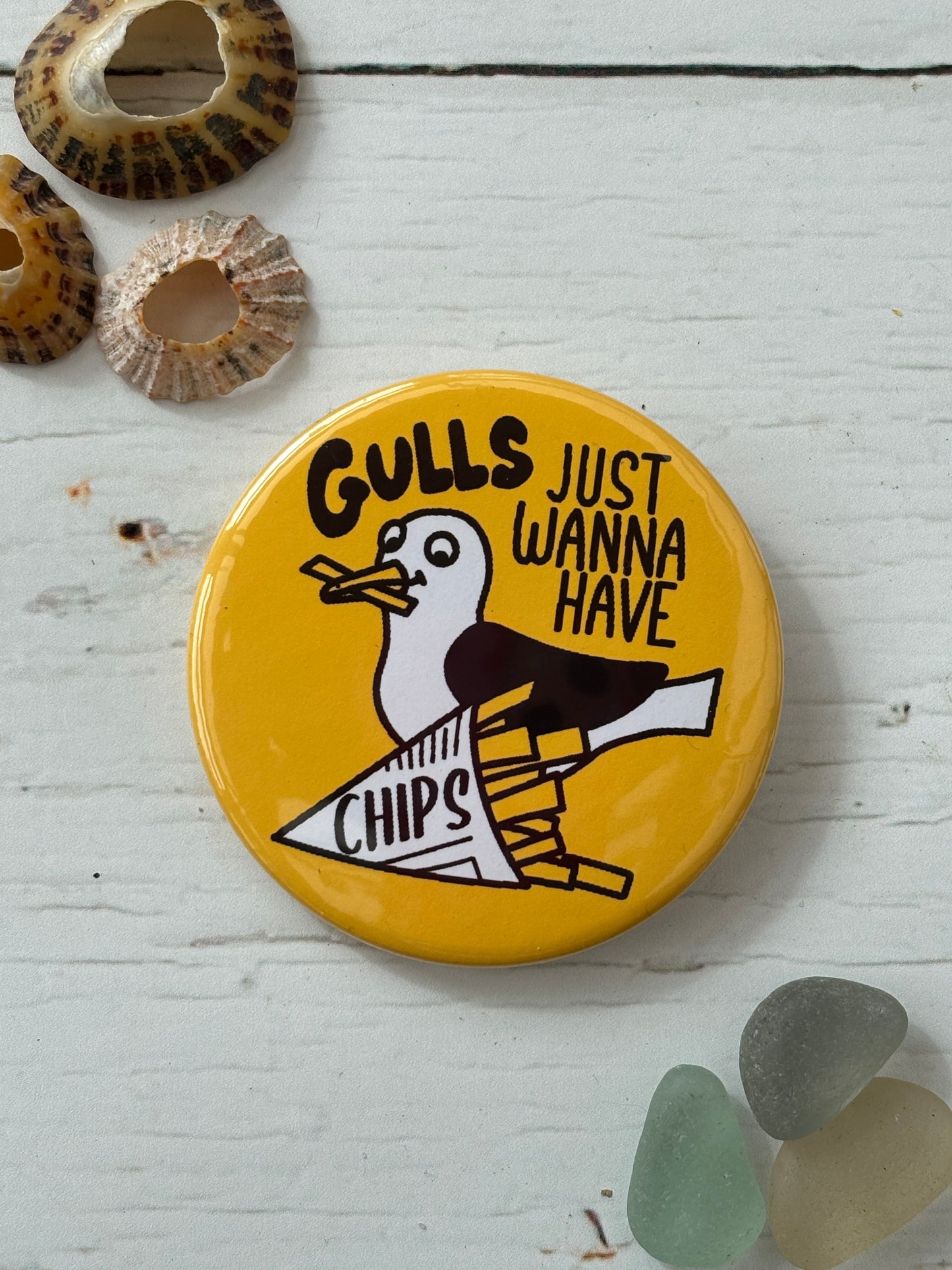 yellow seagull pin badge with the text 'Gulls Just Wanna Have Chips' a funny nautical accessory, great coastal novelty gift for foodies