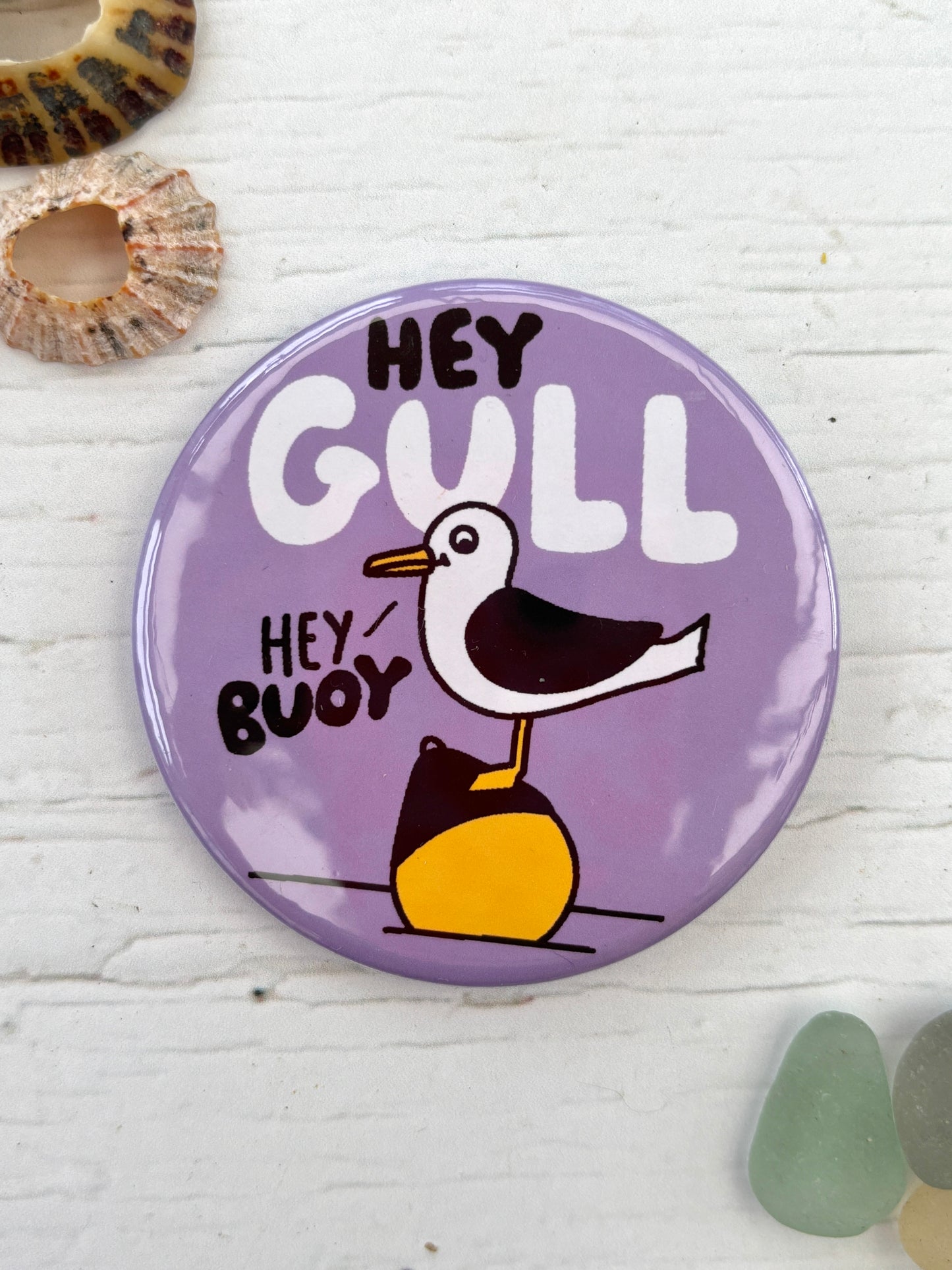 purple seagull badge with the text 'Hey Gull Hey Buoy' a funny novelty pin and nautical accessory great coastal gift for friends