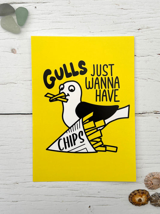 funny yellow postcard with a seagull eating chips and the slogan 'Gulls Just Wanna Have Chips' coastal souvenir or foodie novelty gift