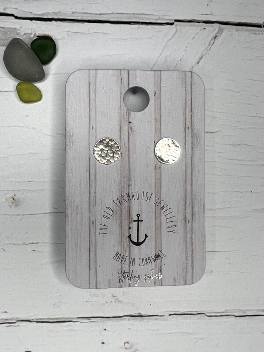 small sterling silver stud earrings featuring a hammered circle texture handmade modern jewellery with a minimalist coastal aesthetic