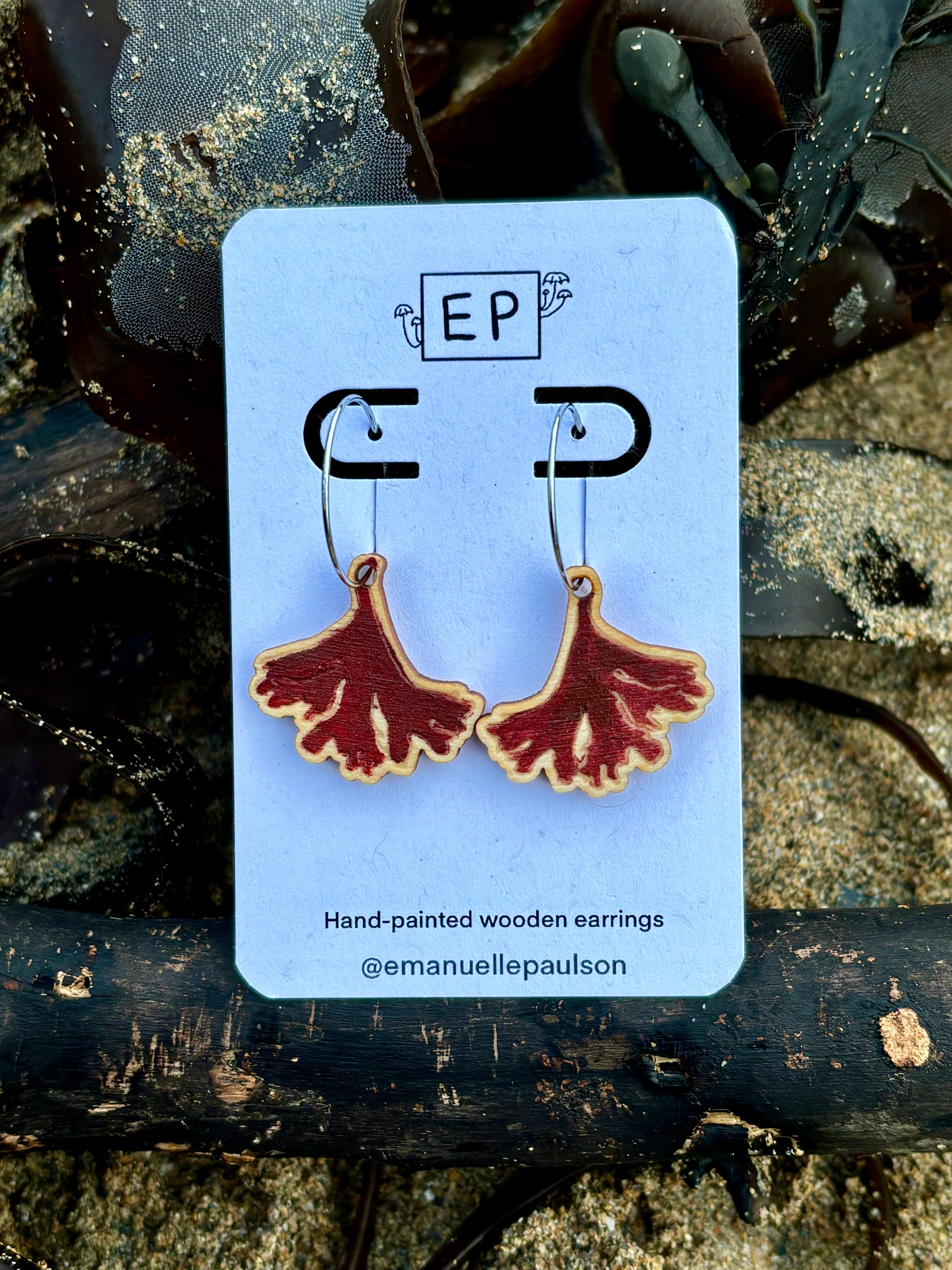 hand painted wooden earrings shaped like red seaweed funky coastal jewellery with a marine life design nautical hoop earrings