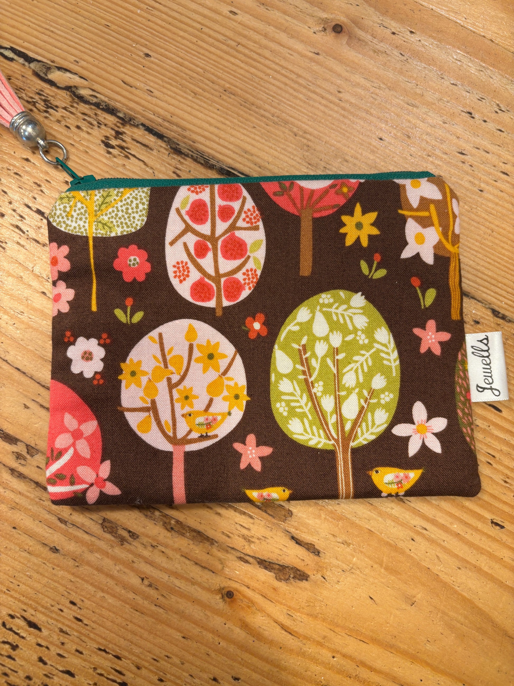 handmade fabric zipped purse with a brown tree and flower print small coin pouch and quirky gift accessory with a pink tassel