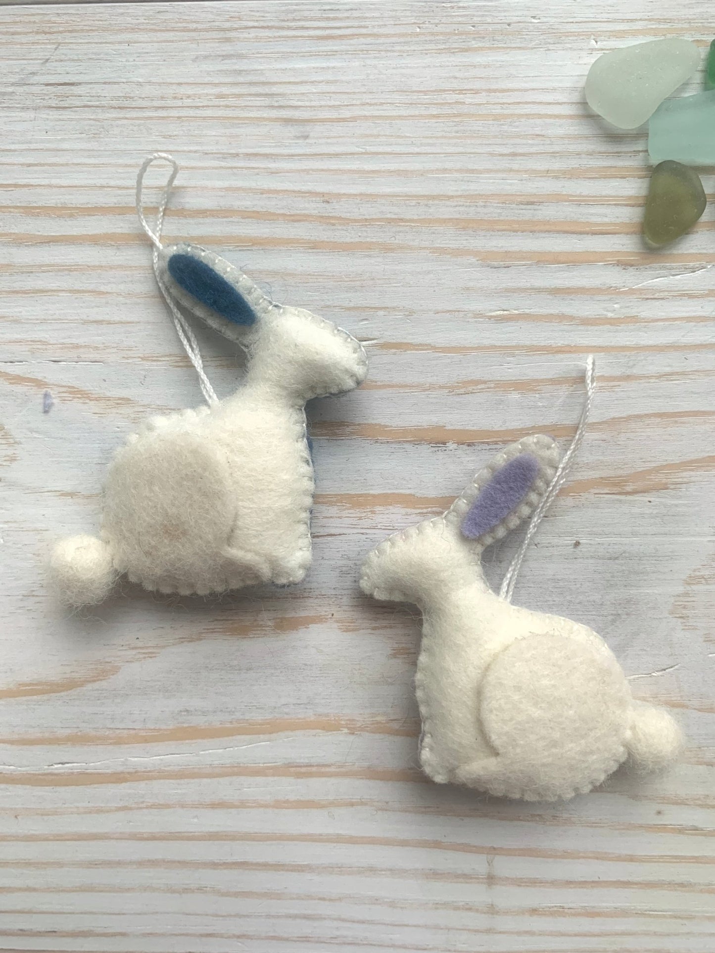 two handmade white felt easter bunny decorations with blue/lilac ear linings spring rabbit ornaments with fluffy pom-pom tails easter decor or kids gift