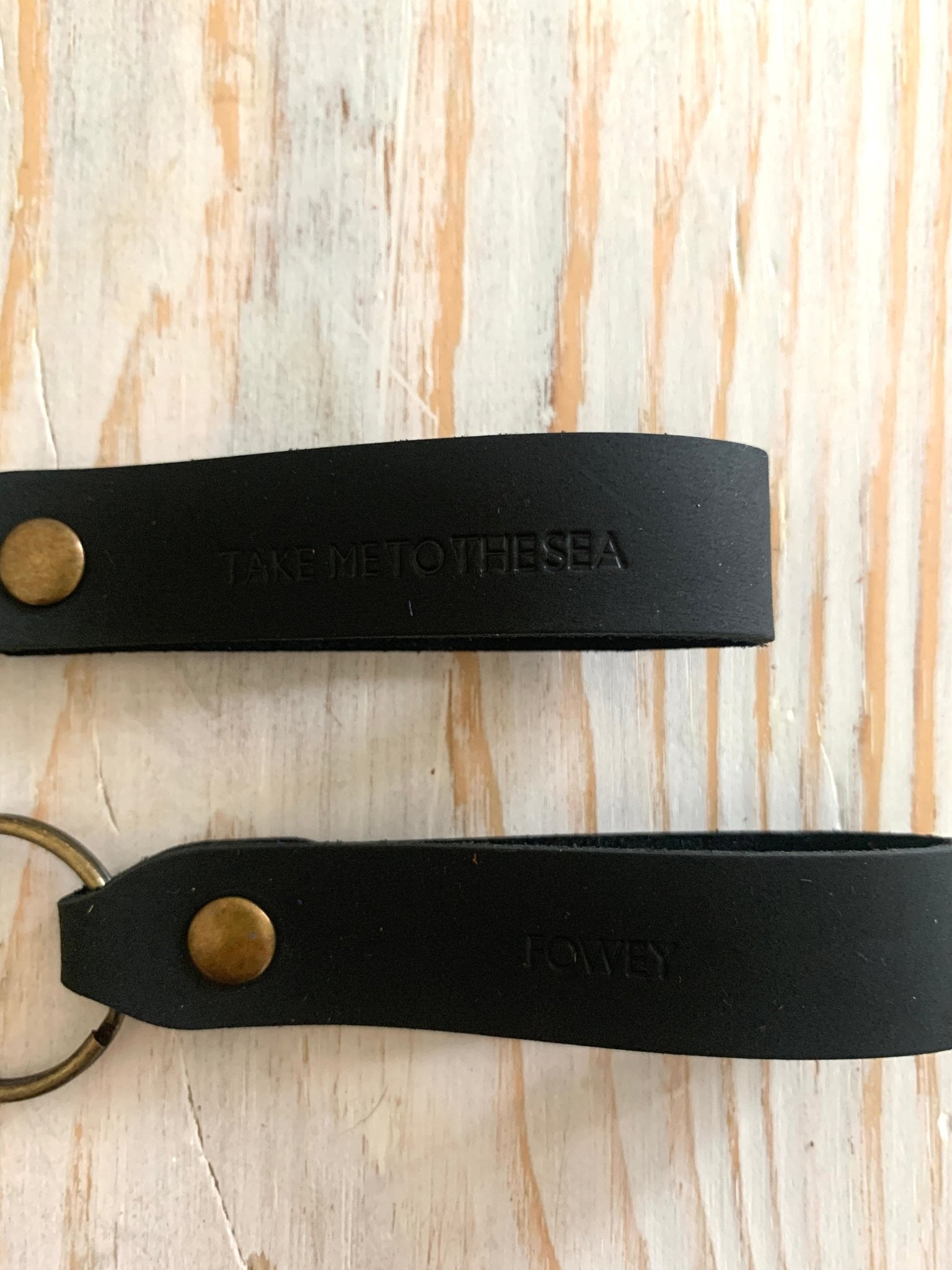 handmade dark brown leather keyring—brass hardware with nautical “Fowey” and “Take Me to the Sea” embossed design