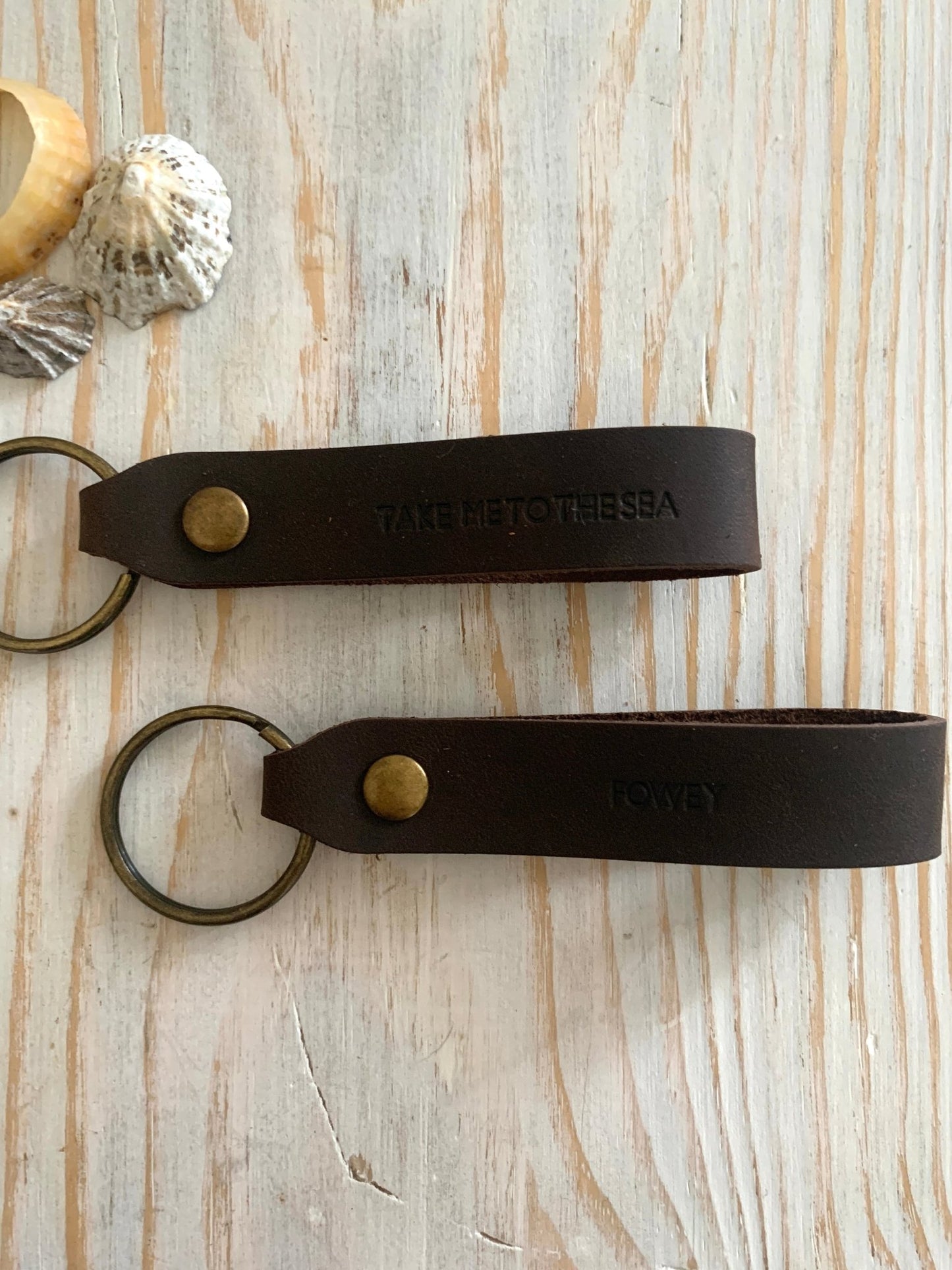 handmade dark brown leather keyring—nautical “Take Me to the Sea” stamp with brass ring and rustic coastal charm