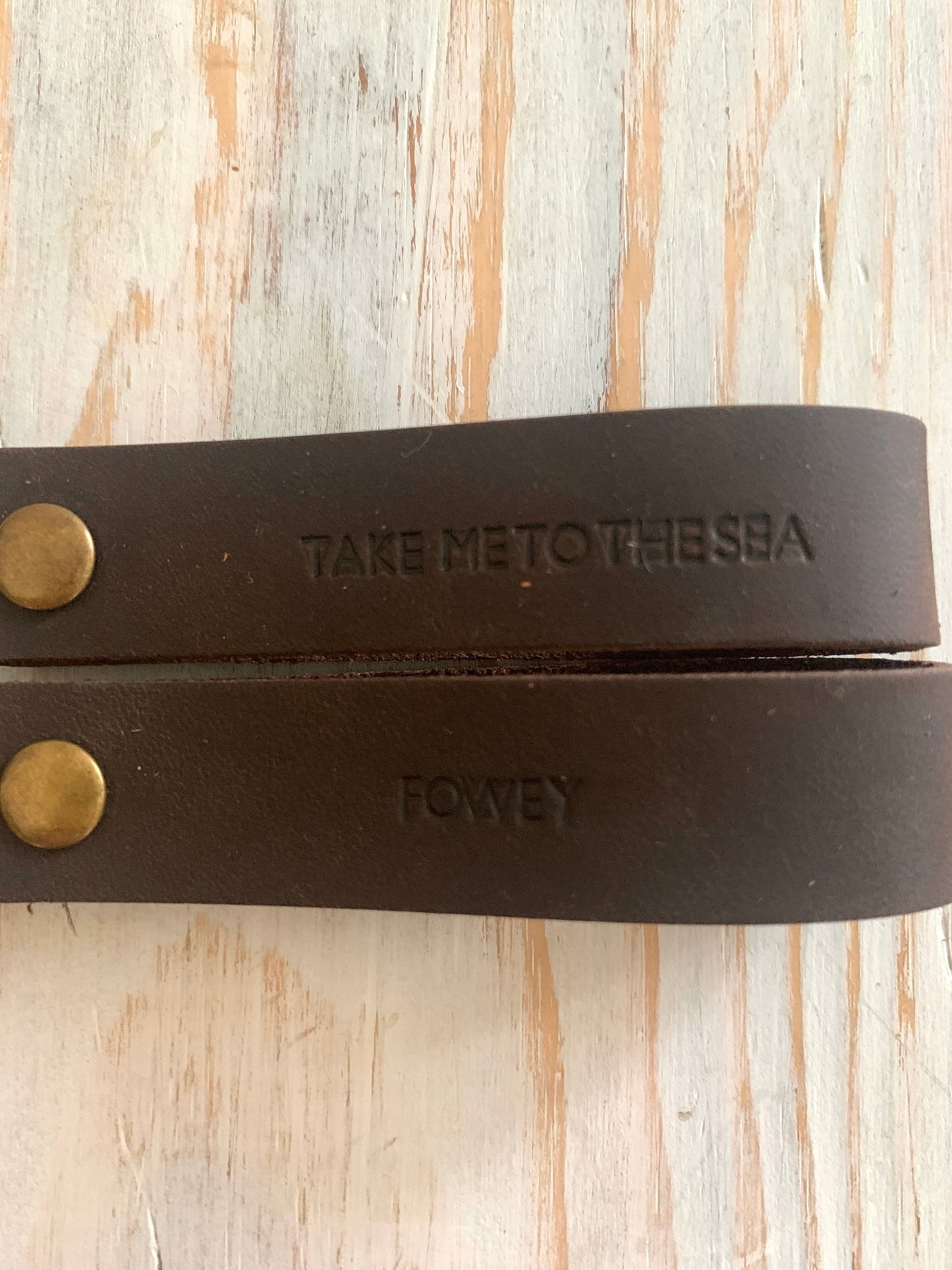 dark brown handmade stamped leather keyring, “Take Me To The Sea” and “Fowey”, rustic coastal gift accessory