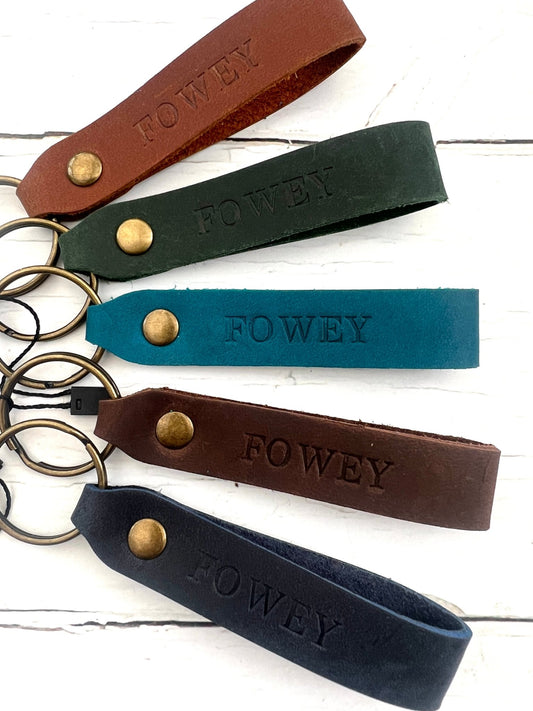handmade stamped leather keyrings with Fowey lettering, rustic loop design, personalised coastal gift, durable keychain accessory