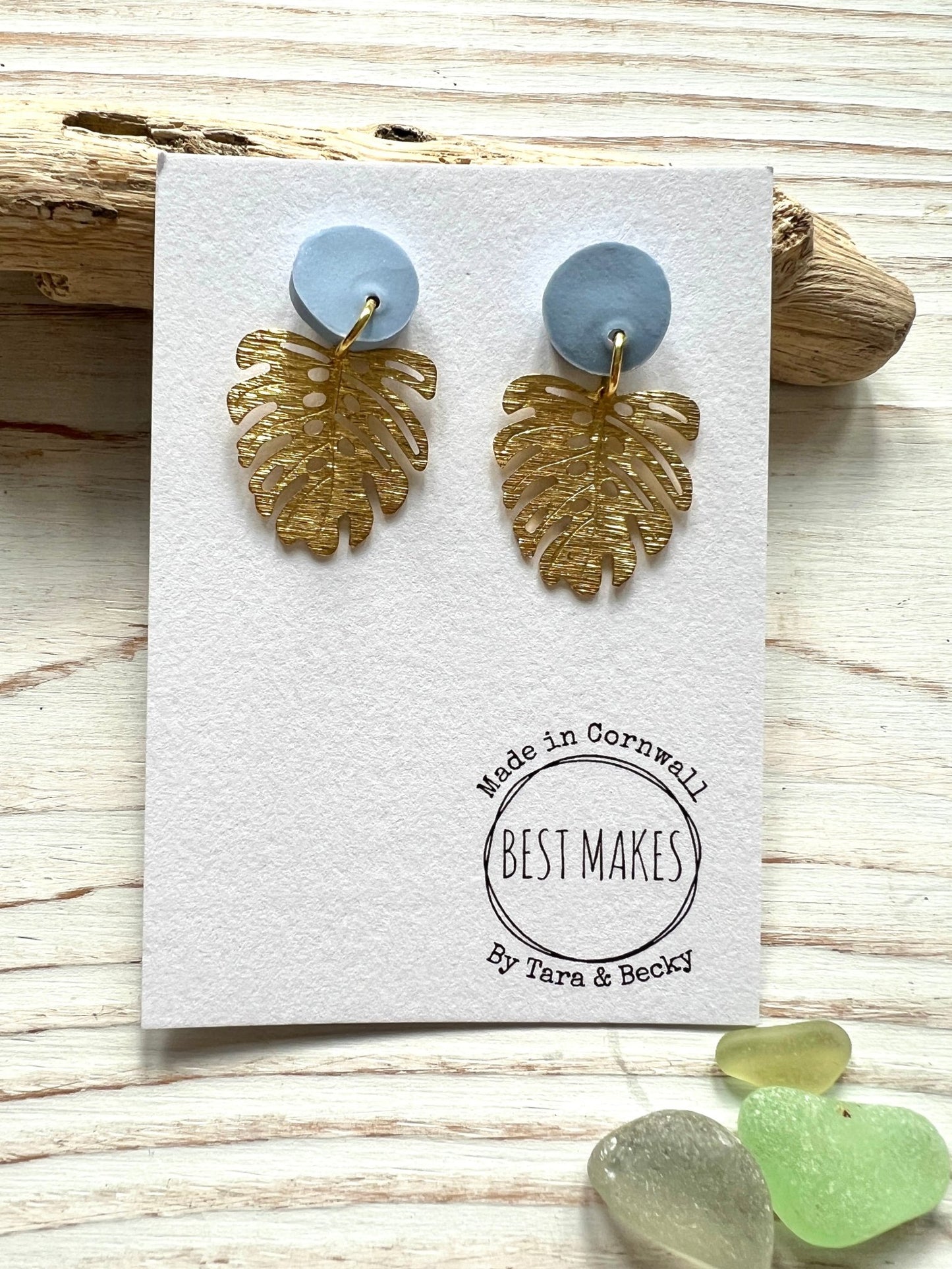 handmade Monstera earrings—light blue studs with gold leaf dangles, tropical botanical gift from Cornwall