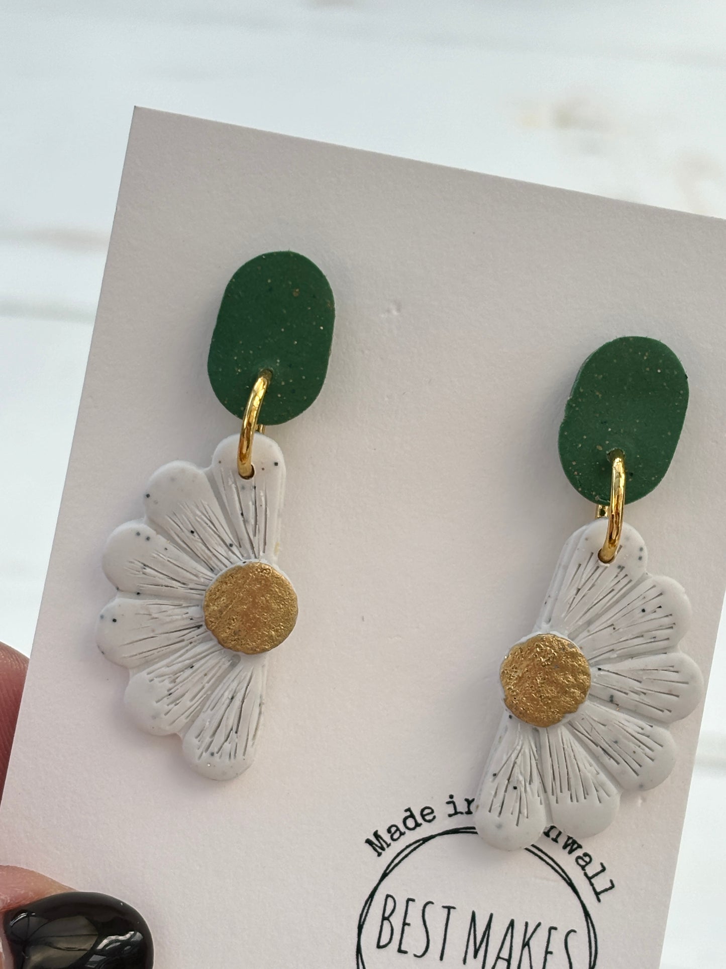 handmade half-daisy earrings—green oval studs with white floral dangles, gold accents, nature-inspired gift