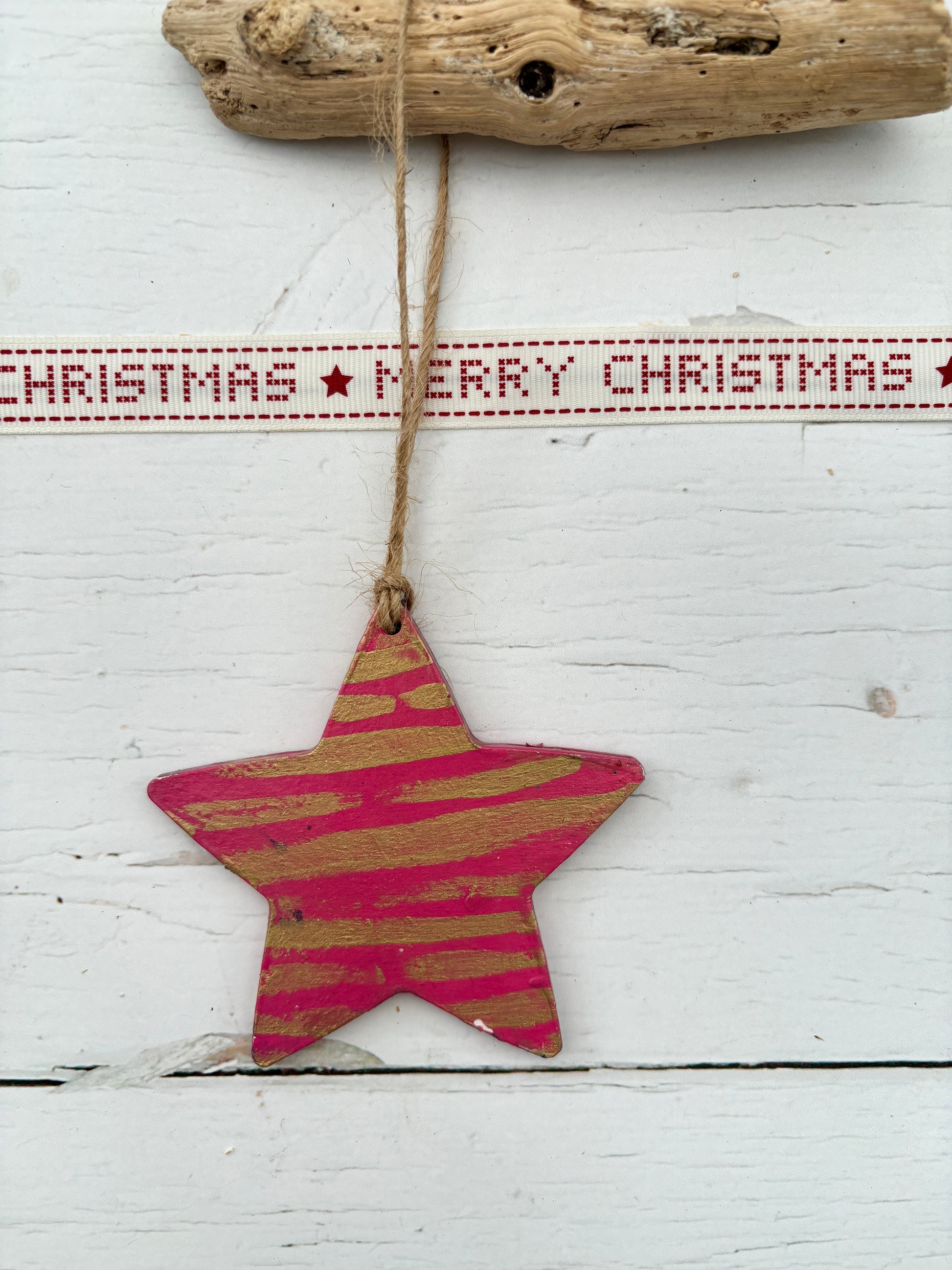 pink hand-painted wooden star decoration with gold metallic stripes hanging from twine rustic Christmas ornament or nautical coastal decor piece