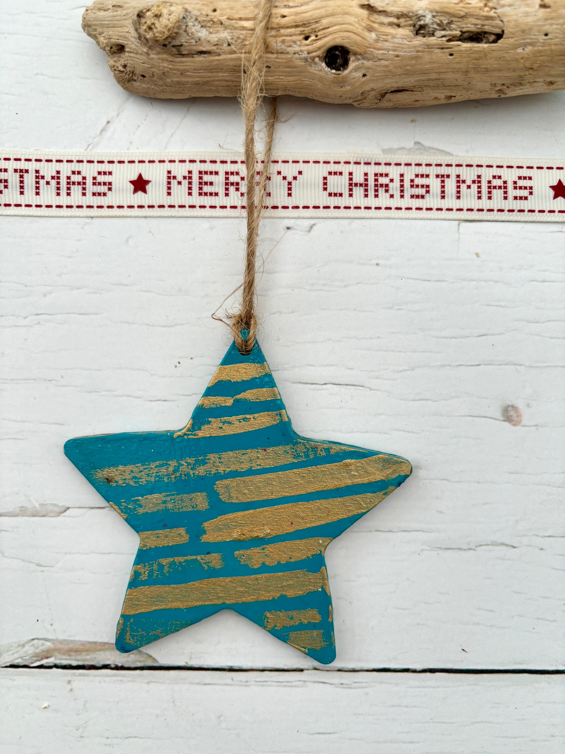 teal hand-painted wooden star decoration with gold metallic stripes hanging from twine rustic Christmas ornament or nautical coastal decor piece