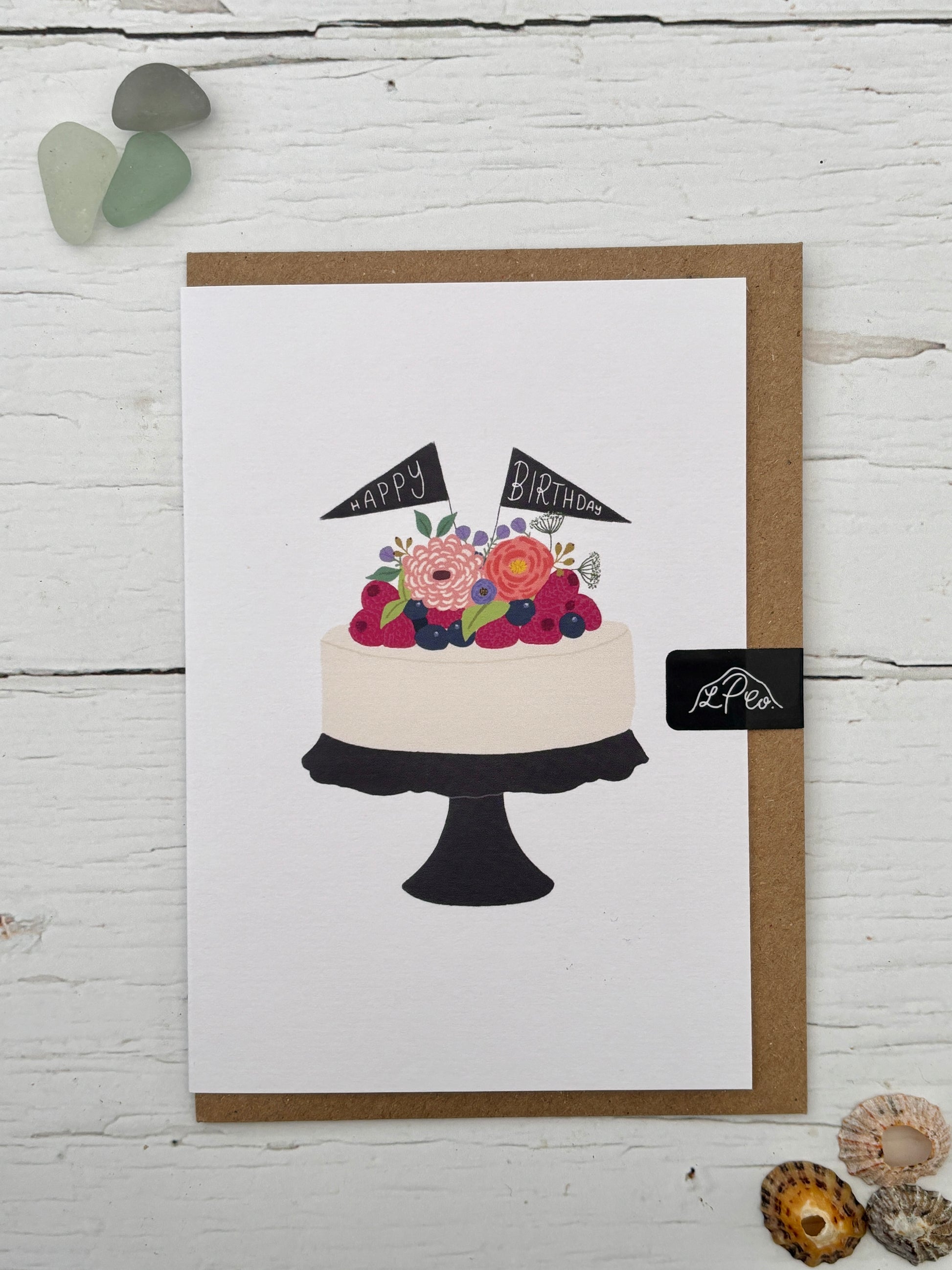 Happy Birthday card featuring an illustration of a floral/berry cake with flag toppers hand-drawn artwork on a kraft envelope celebration greeting card