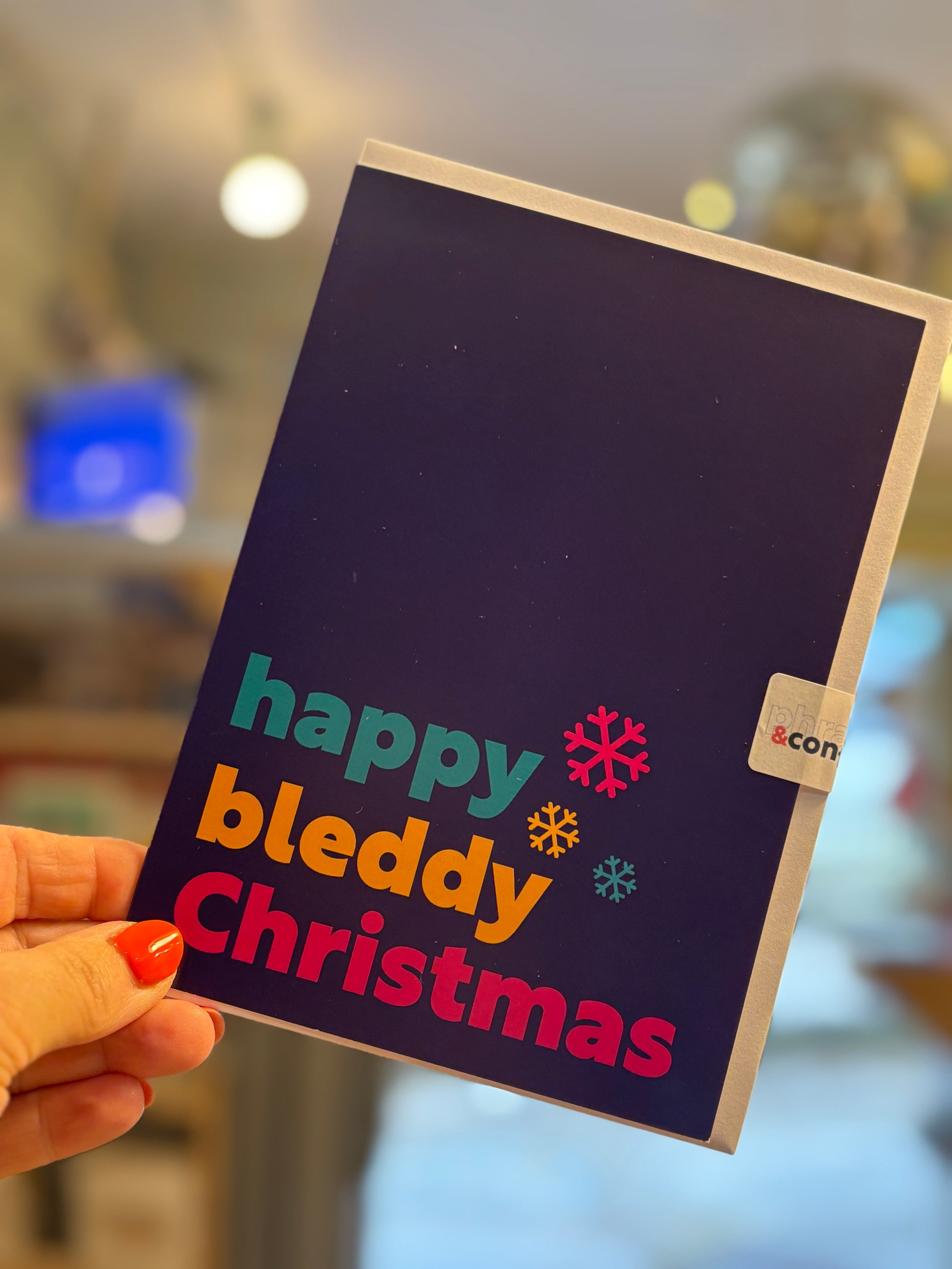 happy bleddy Christmas Cornish dialect greeting card, colorful snowflakes, funny Cornwall slang holiday card design