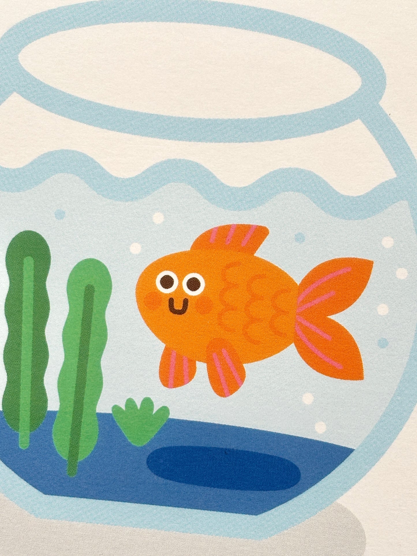 closeup shot of cute goldfish new home card—smiling cartoon fish in bowl with plants, playful handmade housewarming gift