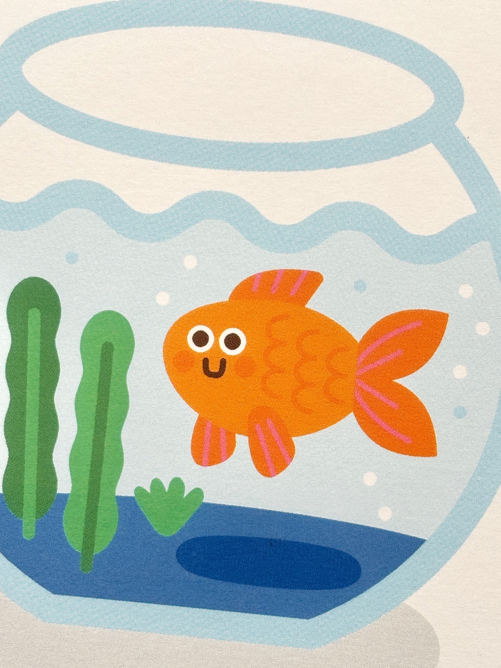 closeup shot of cute goldfish new home card—smiling cartoon fish in bowl with plants, playful handmade housewarming gift