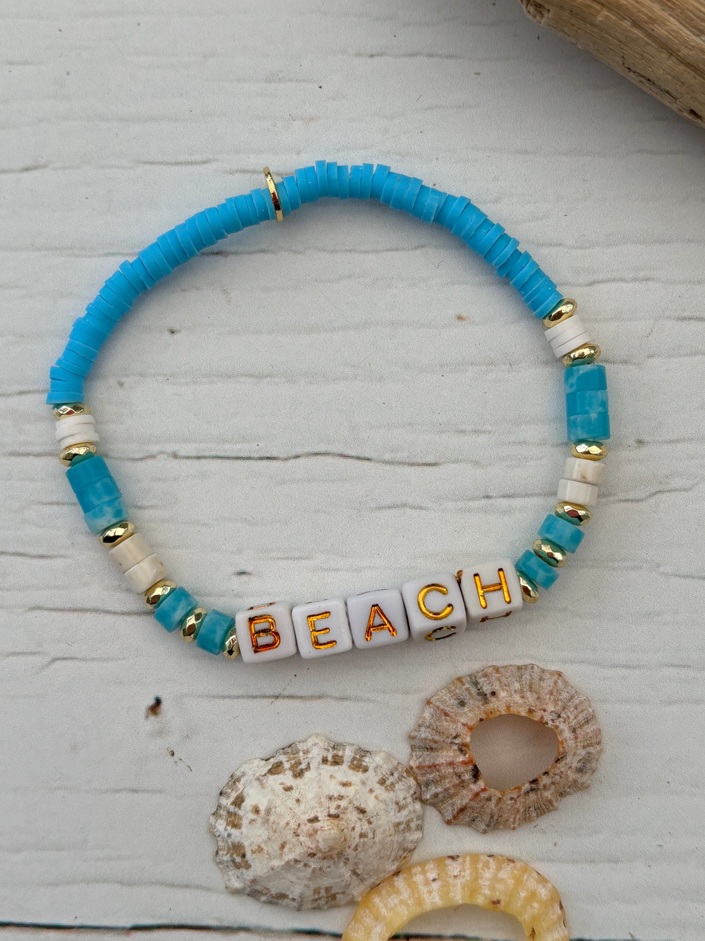 handmade beach bracelet—blue, white, and gold beads with “BEACH” cubes, coastal boho gift for summer vibes