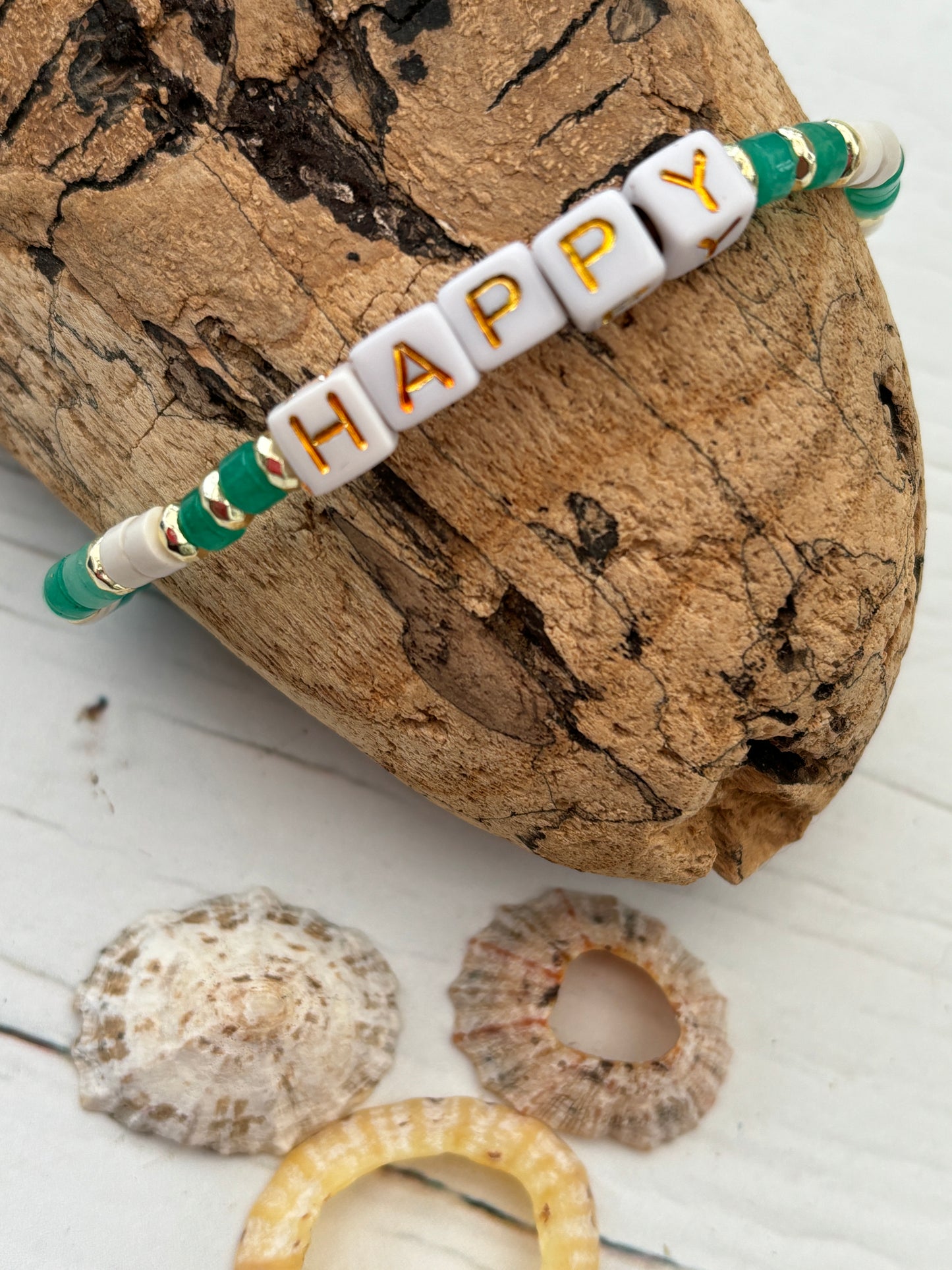 "HAPPY" beaded bracelet—white cube letters with green and gold beads, handmade boho jewelry with beach vibes